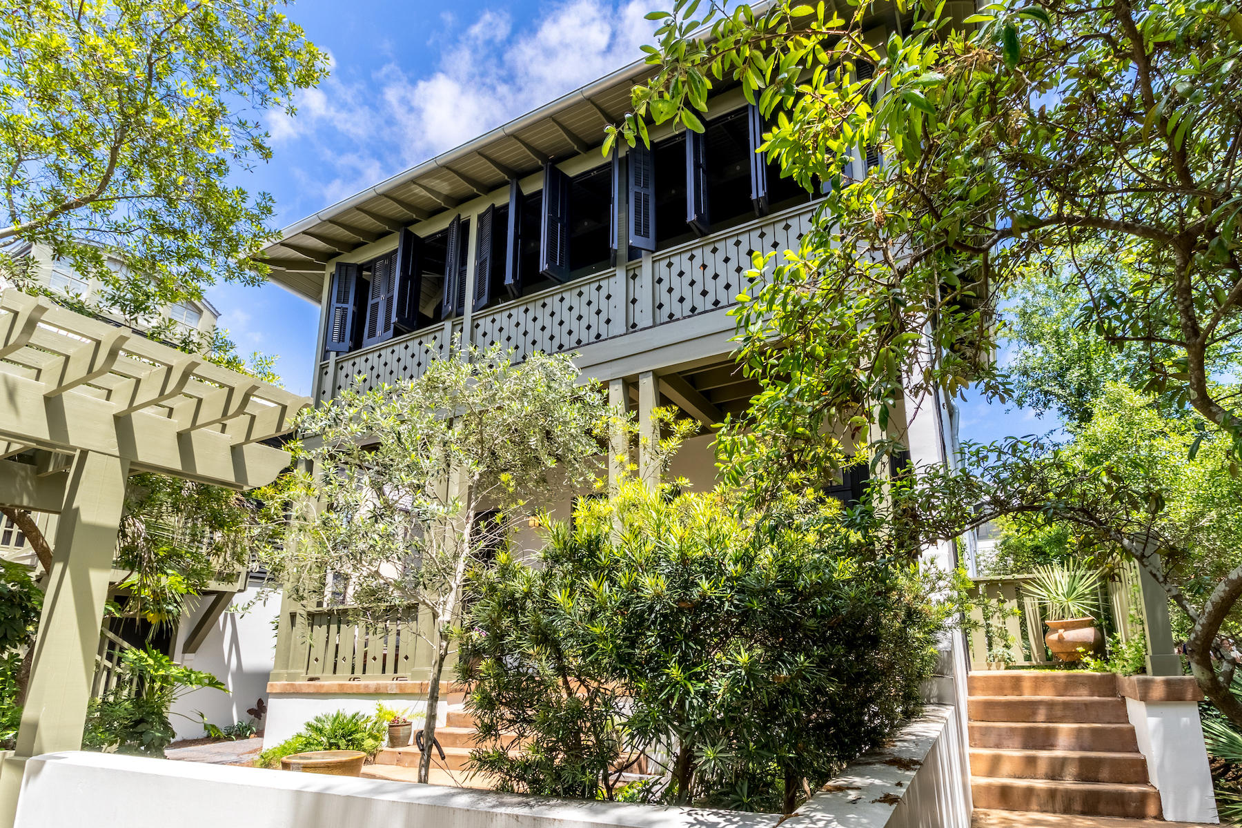 27 Hopetown located on the south side of HWY 30-A in Rosemary Beach is a beautiful beach cottage plus carriage house that is offered fully furnished and completely turn key. This home is conveniently located just steps from the Rosemary town center and a quick walk away from the beautiful beaches of South Walton. You enter the main house through a landscaped courtyard designed with an eye for soothing relaxation. The first level of the home is comprised of two bedrooms both with en suite bathrooms and soaring floor to ceiling windows which help flood the home with natural light. You are greeted on the second floor with cathedral ceilings towering over the open kitchen, dining and living areas. The shutters surrounding the covered porch open to allow breezes to cool the outdoor seating.
