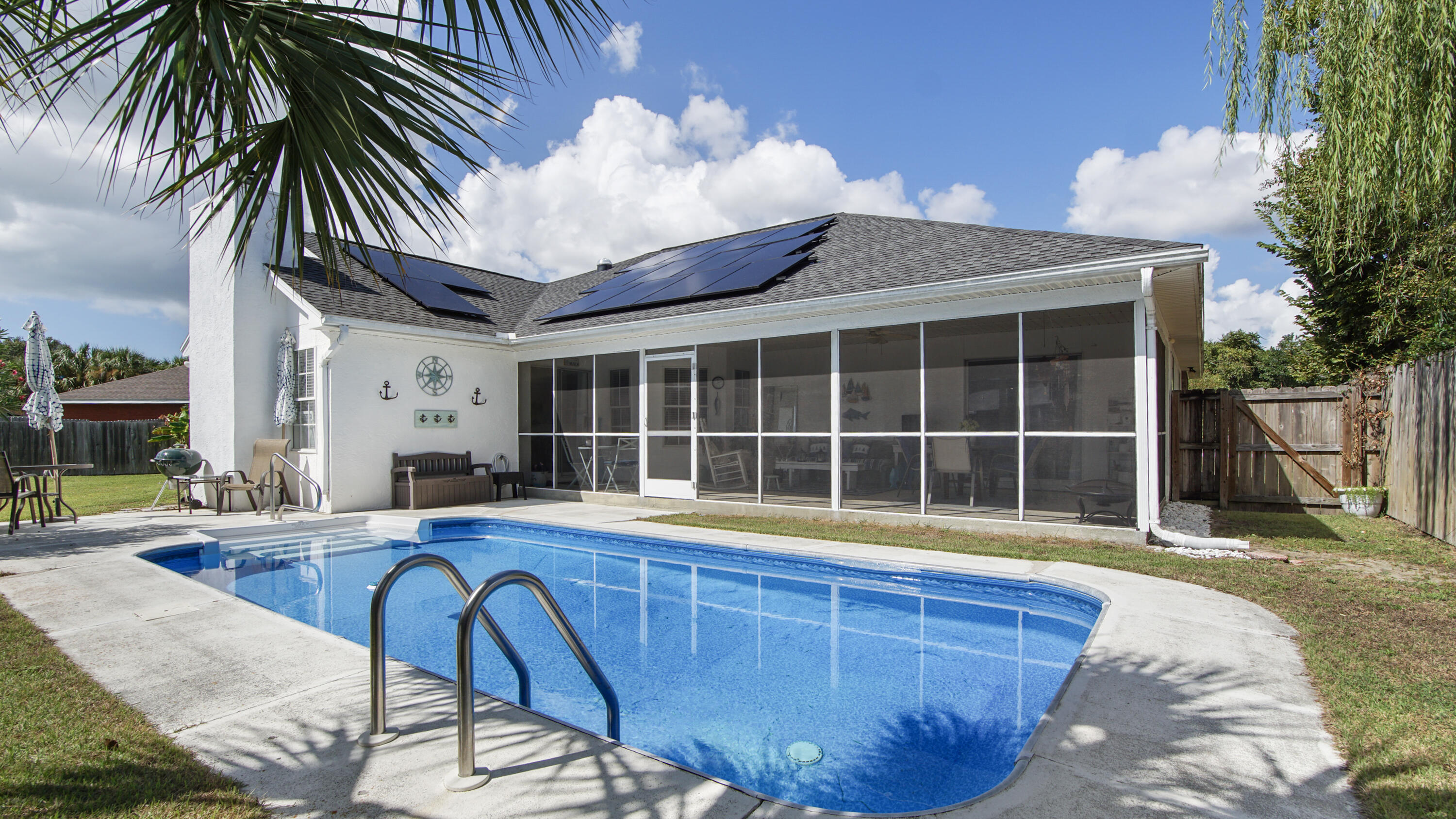 Welcome to 204 Verde Wood Circle, a cozy coastal retreat tucked away on a quiet cul-de-sac just minutes from the world-famous beaches of Panama City Beach. This beautifully refreshed 3-bedroom, 2-bath home perfectly blends comfort, efficiency, and Florida charm. Step inside to find a light, beachy interior with fresh paint and open living spaces that feel instantly inviting. The kitchen and family areas flow effortlessly to a 30-foot screened-in porch overlooking the sparkling in-ground pool, the perfect spot for weekend barbecues or quiet evenings under the stars. The fully fenced backyard offers privacy and space for kids or pets to play, while the two-car garage adds convenience and storage. With a 2024 solar system (loan must be assumed) keeping the average power bill around $30 a month, this home is as smart as it is stylish. Recent upgrades include a 2019 roof, 2018 HVAC, freshly cleaned and sealed ductwork, and a new two-speed pool pump with an easy to clean cartridge filter. Located just minutes from Pier Park, St. Andrews State Park, and the Navy base, this home offers the best of PCB living, and the property can be rented short-term providing even more potential for the property. Your slice of paradise awaits at Verde Wood Circle!