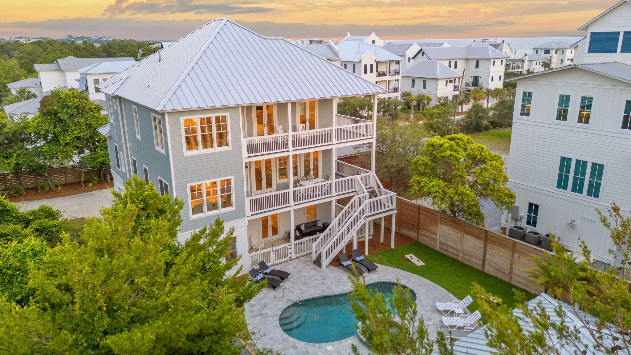 This stunning coastal retreat, just outside Rosemary Beach, has been completely reimagined with a recent renovation in the highly sought-after community Inlet Beach, Florida, where you'll enjoy all that Highway 30A has to offer. This exquisite property on over 1/4 - ACRE with NO HOA offers an unparalleled blend of coastal comfort and convenience in location near 30Avenue, making it a perfect choice for buyers seeking a luxury home at the beach.Spanning 5,067 square feet and offering a residential elevator, the main home boasts 6 bedrooms and 5.5 baths, while the ground level guest house provides 1 bedroom, 2 full baths and a spacious kitchenette overlooking the saltwater pool. This setup on a private oasis provides ample space for family and guests and is designed for multi-family living. The home has been meticulously renovated to offer modern amenities while preserving its coastal charm. With it's proximity to the beach, this property is a gem in the 30A area and desirable for investors with rental projections $285,000-$325,000 annually.
Outdoor living is elevated with a recently renovated heated saltwater pool and spa. The back yard was reinvented with this renovation including new pavers and lounging areas, complemented by upgraded landscaping and a tall privacy fence. New bocce ball court and a green space for corn hole and yard games add to the recreational options for beach living and your guests will love this room in the comfort and privacy of their own back yard. The ground-level guest house makes it ideal for entertaining or accommodating multi-generational living and access for guests while at the pool.
One of the most thoughtful designs in this home is the main home's two oversized primary suites, each with sitting areas to enjoy the Gulf views, large walk-in closets with and spacious en suite bathrooms. This kind of square footage is RARE in homes at the beach and truly live perfectly for a tranquil retreat. A serene and picturesque setting is enjoyed on the wrap around covered porch where you'll enjoy sunsets and see the crashing waves while sipping wine or coffee just off your primary suite.
The main level showcases a great room with soaring ceilings, a kitchen equipped with new Thor refrigerator, gas range and ice maker, custom cabinetry, waterfall Quartz countertops, and a sizable pantry. Adjacent is a dining room that seamlessly connects to a wrap-around covered porch, perfect for enjoying the coastal breeze, stunning Gulf views and al fresco dining year-round. This level also includes 2 guest bedrooms with en suite baths and Juliette balconies as well as a convenient powder room.
The lower level includes a bedroom with built-in bunk beds for 6 and is adjacent to a family room designed for kids and teens to have their own space to hang out at the beach. An additional guest bedroom with a hallway-accessible bathroom provides an additional lower level bedroom. The property also includes two-car attached garages with epoxy flooring and new garage doors. Exit the family room on this level and you'll enjoy the covered porch for grilling and lounging as well as direct access to the saltwater pool and spa and guest house.
Recent renovations have enhanced the property's appeal, including a full facelift with new security system, metal roof, exterior and interior paint, updated pool and spa equipment including conversion to saltwater, new plaster, tile and coping with pavers and more. The guest house features new nano glass sliding doors perfect for entertaining and opening the kitchenette up by the pool, custom cabinetry, quartz countertops, and two fully renovated baths and bedroom. New major systems: HVAC, water heaters, electrical as well as new plumbing fixtures, countertops, cabinetry, and the redesign of bathrooms including new marble and mosaic tiles. Designer lighting, a cohesive color palette with new furnishings and a yard on ??-ACRE at the beach...let's get to the beach!