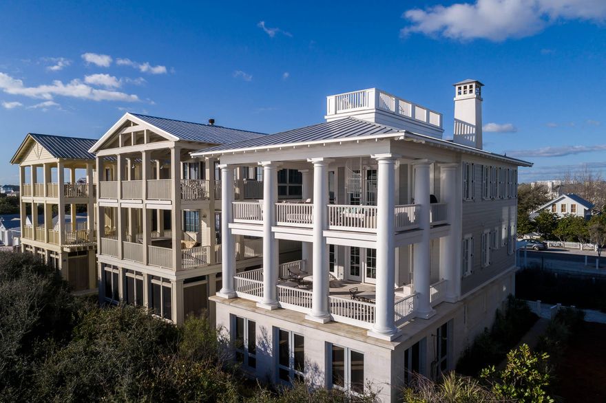 Designed by Don Copper, no detail has been overlooked in this fabulous gulf front cottage located in the heart of Seaside. Three 20'x 28' covered porches, one on each level, are additional living areas overlooking the gulf. Eight 20' tall columns surround the two upper porches. Epay wood imported from Africa was used on the porches and roof deck. Hand blown glass chandeliers hang from the foyer and at each landing as you climb the beautiful stairway. First level includes three guest bedrooms, 2 queen suites and bunk room with three sets of bunks. Each bedroom has its own private bath. Laundry also on first level. Stained wide plank wood floors give balance to the light colors of the interior finish. Dumb waiter services all floors for ease in transporting groceries and luggage. Two master