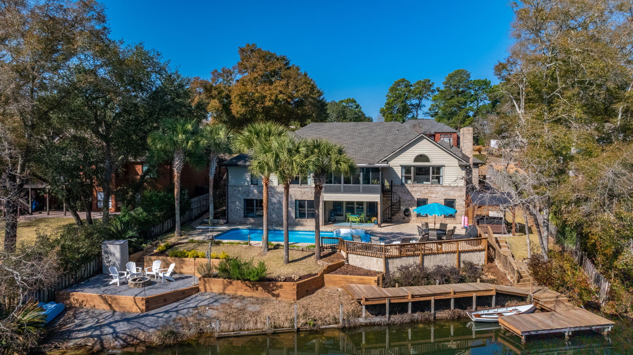 Welcome to this exquisite 6-bedroom, 4-bathroom home nestled in the heart of Rocky Bayou Country Club Estates on the shores of Lake Henderson. This breathtaking home where tranquility meets modern luxury features 4,116 square feet of living space adorned with elegant finishes and an abundance of natural light.This is a home where you can both relax and entertain. The heart of the home features a chef's kitchen equipped with top-of-the-line appliances, large island, motorized blinds and lake views from every window. The kitchen seamlessly transitions to a generous living area with a fireplace overlooking the beautiful lake where nature can be seen firsthand. You will love having your morning coffee while looking at otters, blue herons, soaring bald and golden eagles.More .... The primary suite offers a serene escape where you will awaken every morning to stunning tranquil lake views. The spa-like bathroom will take your breath away with an art-inspired soaking tub, a gorgeous chandelier, walk-in shower with shaving niche and his and her closets.
The main floor also has a flex room, 3 additional bedrooms, the first of two laundry rooms and the unmistakably beautiful dining room. Lastly, you can relax and enjoy the 4-season room that provides secondary access to the pool level.
As you descend the stairs to the lower level where every room has views of the lake, you'll be taken aback by the expansive living area, a second kitchen perfect for entertaining outdoors, a second laundry room and two exceptionally large bedrooms with large walk-in closets, built-ins and newly renovated on-suites. The owners also have added what every homeowner needs, an abundance of storage which you will have to see to believe.
At this exclusive residence, be pulled away by the allure of the outdoor living, an entertainer's dream, set against the backdrop of the picturesque lake and beautiful palm trees. Here you can relax and entertain in the sparkling pool and hot tub, make smores in the firepit area, sunbath on the expansive deck, fish off the newly renovated dock and stairs or kayak on the lake.
Completing this exceptional property is a spacious 3-car garage, with professionally installed epoxy flooring and new hurricane-rated garage doors.
The owners have also updated things not seen in the photos which include: a brand-new roof (2025), foam insulated attic space, including the garage, recessed lighting with dimmers, motorized blinds on the front of the house and so much more. This house also comes with a full-house generator.
Once you decide to leave the house, the Rocky Bayou Country Club with renowned golfing, a swimming pool and club house is minutes away by golf cart with access just down the street. You are also just minutes from shopping, beautiful emerald water beaches, Eglin and Hurlbert Air Force Bases, Duke Field, 7th SFG and everything else the area has to offer.
Don't miss this rare opportunity to own a truly one-of-a-kind home on peaceful Lake Henderson in the heart of the highly sought after Rocky Bayou Country Club Estates.