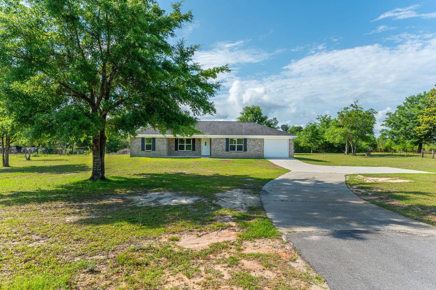 Charm & Character awaits in this picturesque 3 bd, 2bath brick home situated on over an acre.  Covered front porch is ideal for a pair of chairs to relax and drink a glass of tea. Come on in to open, split floor plan, light and bright!  Galley kitchen offers stainless steel appliances, open dining/living. In-door laundry room with cabinets & folding table.  Tile in all wet areas to include the dining with carpet in living and bedrooms. Primary bath has walk-in shower and large vanity.  Back covered porch is 8X12, niiiice size for shade or cover while enjoying the outdoors, bird watching, kids playing, or just relaxing in the fresh air. Driveway has RV parking with electric for guests that may want to stay a minute, an added plus! Standing Ovation for Baker location!