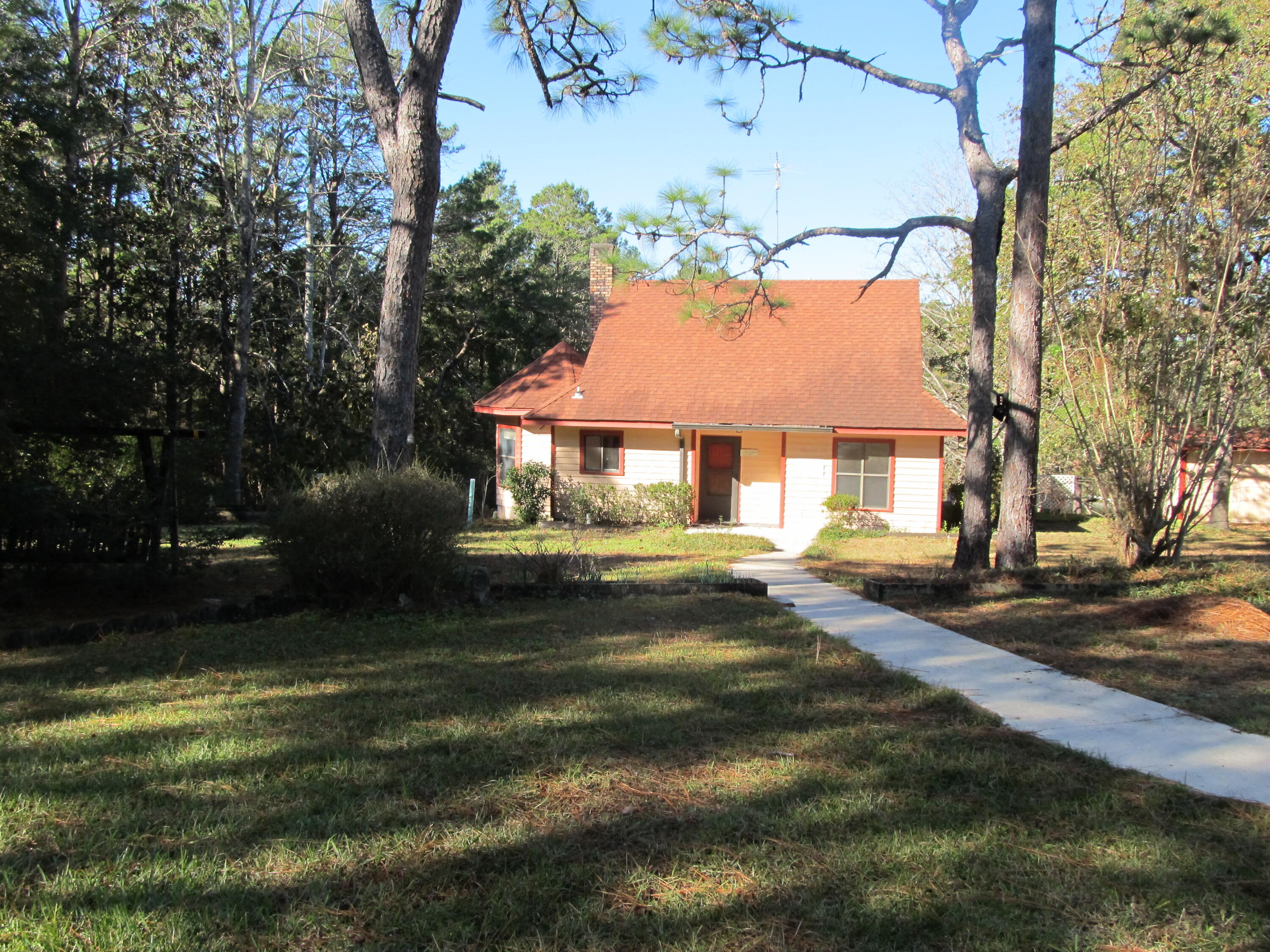 Nestled on 2.79-acres, this 4 bedrooms 2 bath, two-story home offers a private escape with approximately 360 feet of waterfront on Lake Tantara. Imagine waking up to serene lake views from your primary bedroom, complete with a cozy 14 x 18 sunroom perfect for those lazy Sunday mornings. Home is designed with three bedrooms and a flex room on the lower level that's ideal for an office. On chilly evenings, relish the warmth of the wood burning fireplace that adds a touch of rustic charm. Outdoors, your private paradise features several garden areas maintained with well water, a spacious 12x20 workshop, and additional covered storage. This property is a haven for anyone seeking privacy and tranquility while putting their own flare into home. Roof 10 years old and HVAC replaced in 2022.