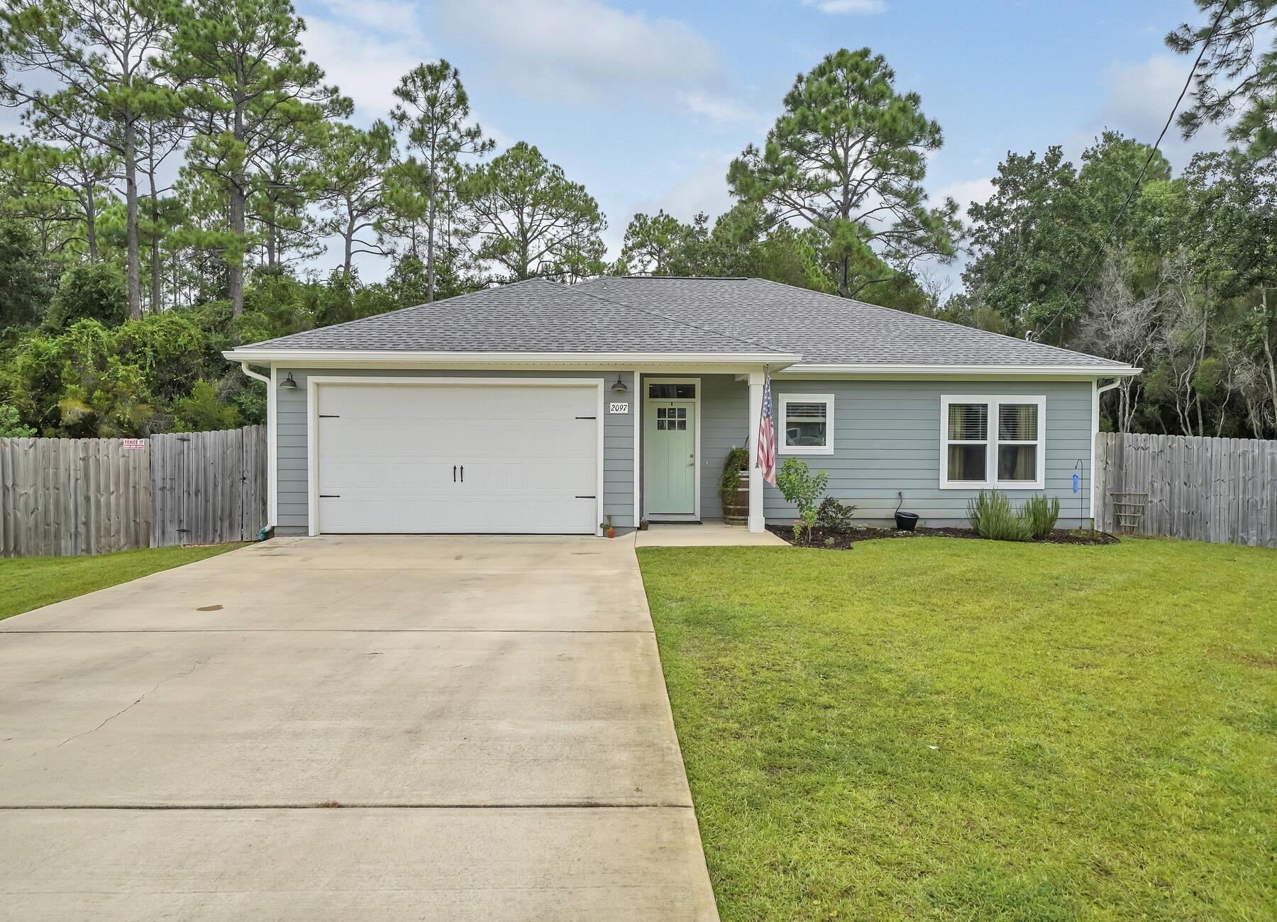 Welcome to 2097 Constitution Drive, where elegance meets coastal charm in beautiful Navarre, FL. This meticulously crafted home is a true masterpiece, boasting a blend of modern luxury and serene tranquility. Step inside and be captivated by the open-concept design that seamlessly connects the spacious living area with the beautiful kitchen, perfect for both entertaining and daily living. Wood look tile floors, high ceilings, and an abundance of natural light create an inviting atmosphere that will make you feel right at home. The kitchen is a dream, featuring stainless steel appliances, granite countertops, and ample storage space. Imagine preparing culinary delights while enjoying the company of loved ones seated at the breakfast bar.