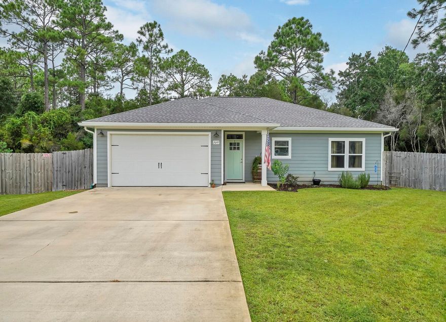 Welcome to 2097 Constitution Drive, where elegance meets coastal charm in beautiful Navarre, FL. This meticulously crafted home is a true masterpiece, boasting a blend of modern luxury and serene tranquility. Step inside and be captivated by the open-concept design that seamlessly connects the spacious living area with the beautiful kitchen, perfect for both entertaining and daily living. Wood look tile floors, high ceilings, and an abundance of natural light create an inviting atmosphere that will make you feel right at home. The kitchen is a dream, featuring stainless steel appliances, granite countertops, and ample storage space. Imagine preparing culinary delights while enjoying the company of loved ones seated at the breakfast bar. Retreat to the luxurious master suite, a haven of relaxation with its spa-like ensuite bathroom and walk-in closet. Two additional well-appointed bedrooms offer comfort and versatility, accommodating family, guests, or even a home office. The large backyard features a patio area where you can sip your morning coffee while enjoying the gentle coastal breeze.