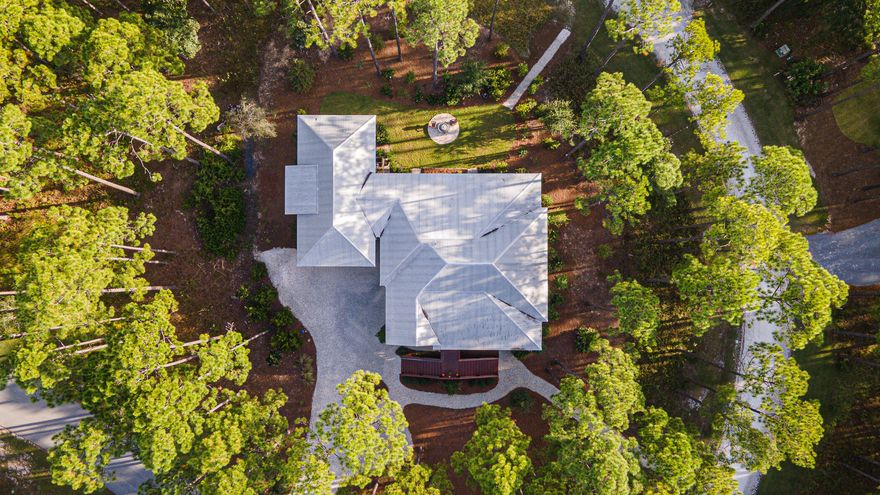 **New Pool Opening Soon** Discover the allure of RiverCamps on West Bay, a premier gated community in Panama City Beach, offering a perfect blend of nature and luxury. This custom-built home, poised on a spacious 1.12-acre lot with potential for a private pool, features a large open floor plan with vaulted ceilings, 4 bedrooms, an office, writing nook and the convenience of an elevator. Enjoy outdoor living on 4 large porches, 3 screened, including an 2 outdoor fireplaces and TV, ideal for relaxing or watching sports. Residents of RiverCamps enjoy access to boating, fishing, paddleboarding, and a 7-mile nature trail, alongside an onsite boat ramp, boat storage, and the upcoming new clubhouse and resort-style ammenties. One of the fastest growing areas in Panama City Beach.