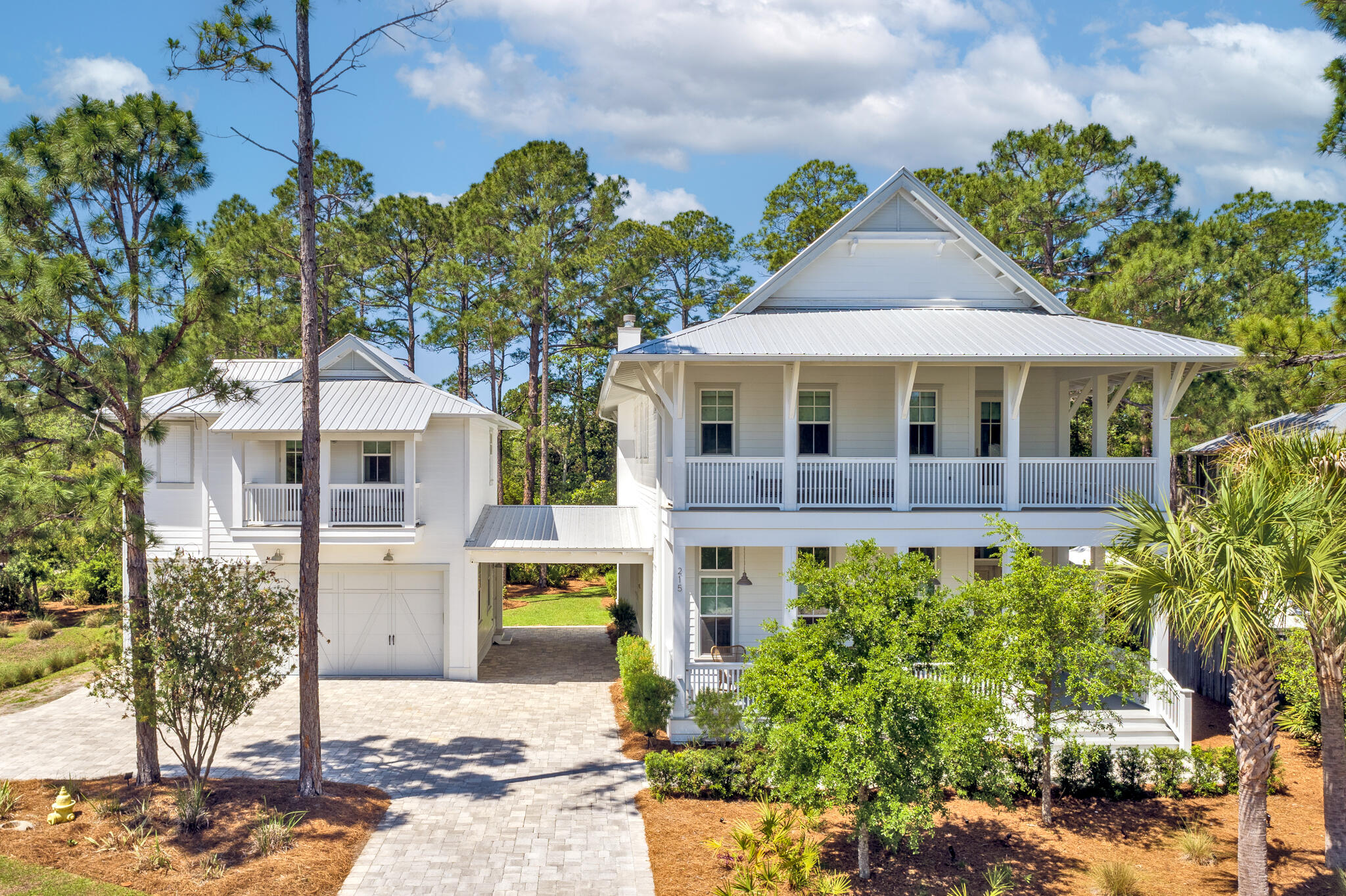 A true sense of serenity awaits at this impeccably appointed 7BR/6.5BA Seagrove Beach home with a private pool located only a block from Scenic Highway 30A and just a short stroll from Seaside. Nestled on a corner lot on a secluded street, this property is surrounded by protected wetlands to the rear meaning your peaceful woodland views will always remain. With 4,100 square feet of thoughtfully designed living spaces, this property encompasses a 5BD/4.5BA main home and a 2BR/2BA carriage home over an oversized 2 1/2 car climate-controlled garage.Hand-carved French doors welcome you into the bright and spacious living and dining spaces highlighted by 12' coffered ceilings, shiplap walls, hardwood floors, and custom built-ins.