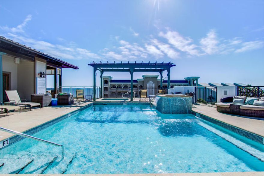 Resort style living in the highly sought after Waterhouse Condominiums, a luxurious property with deeded beach access and beach chair service just a short walk from your private lanai. Ground floor convenience allows you to park in front of your door and take your luggage or groceries straight in to your home. Amenities include amazing rooftop pool and hot tub with stunning views, beautifully appointed owners lounge with gourmet kitchen, party room and entertainment center, big screen TV, fitness center, steam room and sauna. The home has a spacious, open floor plan on one level with 10' ceilings, hardwood flooring throughout main living areas, wall of floor to ceiling sliding glass doors. Beautifully furnished, stove, built in fridge and a/c have all been recently replaced.