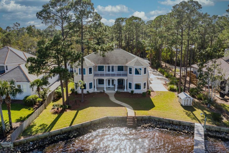 Wake up to a gorgeous sunrise over the bay! This Mediterranean style home is perfect for family gatherings or peaceful  afternoons on the water.  Master on the main overlooks the bay and steps outside to a large patio.   This five bedroom, four and a half bath has a separate living area upstairs equipped  with 3 bedrooms, common area, kitchen and bath with it's own private entrance.  This guest area also has a beautiful covered porch overlooking the bay.   The yard is well maintained and beautifully landscaped and leads to a boat dock equipped with boat lift.  Spacious open floorplan with enormous high ceilings.  The chandelier in the living room even has an up/down automated feature for cleaning.  This living area also opens to the patio overlooking the bay.  
.