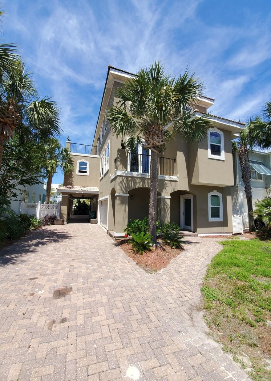 DIAMOND IN THE ROUGH! This beautiful 3 story 4 bedroom 4 bath home near the water is stripped down and ready to be remodeled to your liking! Beautifully paved yard. Spacious patio on ground level. Balconies on second and third floors. Main floor features one full bedroom and bathroom, built in bunk area, plus kitchenette/living room. Second floor is the main living space with formal dining room, large kitchen, spacious living room with fireplace, and two full bedrooms and bathrooms. Third level features an additional living space, kitchenette area, and one bedroom and full bathroom. This property is distressed, and is in need of updates and TLC, but it is the perfect opportunity to customize this one-of-a-kind property to your liking!