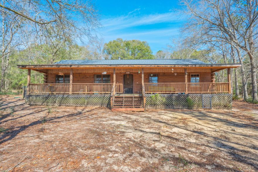 WELCOME HOME TO YOUR OWN LOG CABIN on a peaceful one acre lot! Enjoy your morning coffee and a terrific view of the surnrise on this HUGE covered front porch, spanning the length of the house! Curl up with some hot cocoa on chilly evenings by the wood burning stove in the living room. Four bedrooms and two baths with primary bathroom featuring a walk in tile shower. Workshop, private well, fenced yard. HVAC 2019, ROOF 2019