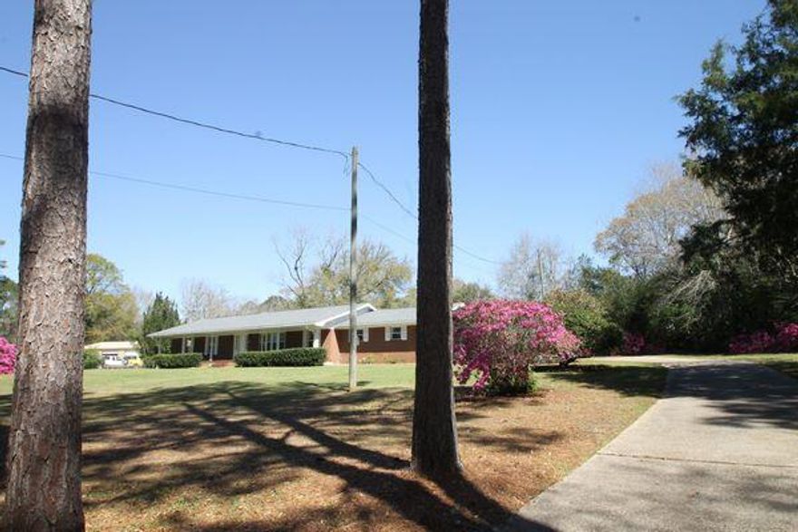 Really nice property in central Crestview. All brick 2480 square foot home on a large 1.02 ACRE LOT! Located at the end of a dead end street that affords a lot of privacy and extra parking! Sturdily  built  in 1965 this home has had extensive and recent remodeling. The interior has original terrazo floors which are in excellent condition as well as new laminate floors in the kitchen and family room. A brand new Trane HVAC system was installed in 2023 along with all new double paned windows. New rain gutters, new interior paint, and a kitchen remodel to include new cabinets, sink, tile backsplashes, and quartz counter tops. Dishwasher and refrigerator were replaced in 2023.  The super large fully fenced lot has many mature shrubs and beautifully flowering plants. This is a great home on a huge lot. It's vacant and ready for you!