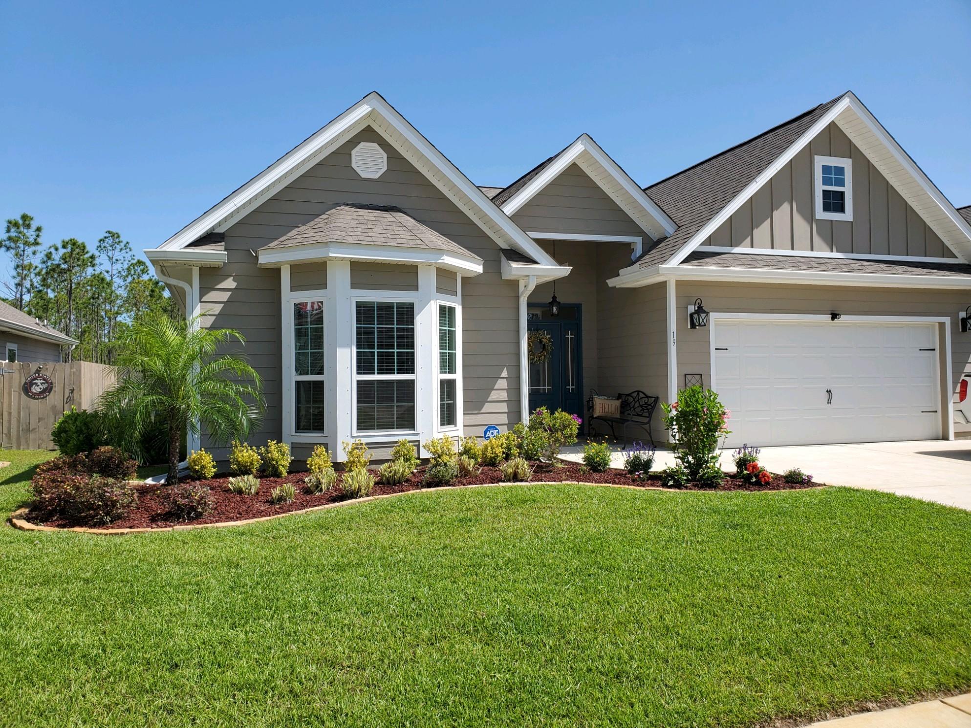 WELCOME HOME to beautiful 19 Eagle Haven Drive. Colorful landscaping and well maintained exterior lead you to the tasteful covered porch with gutters. When you enter the oversized foyer you will notice the tray ceiling and double crown molding as well as the custom wainscoting. Off the foyer to the left you will find the spacious guest bedrooms featuring a charming bay window and a guest bath. To the right off the foyer you will find the entrance to the oversized 2 car garage as well as the entrance to laundry. Going forward you enter the wide open concept living space with a tray ceiling and crown molding feature, dining space and kitchen. You see nature from the minute you open the front door due to the back of the home being a wall of windows with a view to your oversized lot.