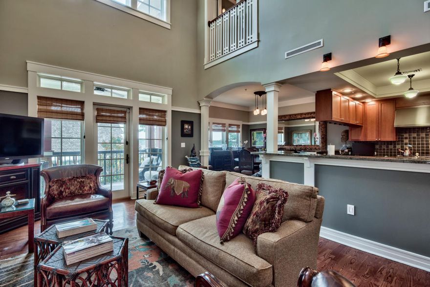 Motivated seller! Sold partially furnished.Absolutely stunning waterfront masterpiece located on the rare coastal dune lake, Lake Powell, in prestigious Wild Heron. This four bedroom, three and one half bath two story townhome-style condo boasts an expansive 2,242 square feet and vaulted, two story ceilings that allow an abundance of natural light to showcase the exquisite detail of this custom condo. Quality craftsmanship is exhibited in every facet of this condo including large windows, crown molding, hardwood flooring with custom inlays in main living areas, porcelain slate flooring in bedrooms, and Jerusalem stone countertops in bathrooms. The first floor was designed specifically for entertaining as it opens seamlessly from the kitchen to the main living area.