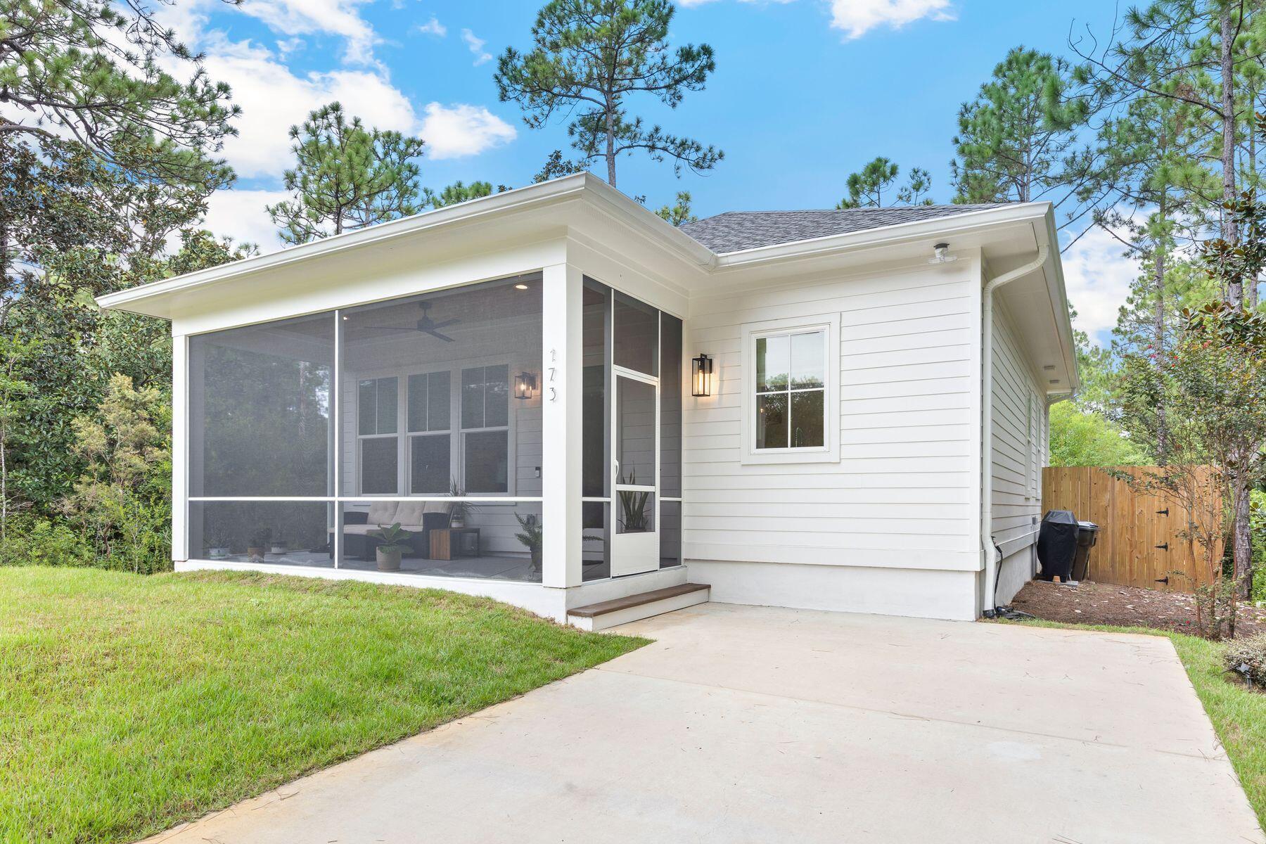 Tucked away on an end of street location in Santa Rosa Beach, this coastal-inspired home blends privacy, comfort, and style. With 1,050 square feet of thoughtfully designed living space, the open layout, vaulted ceiling, and sunlight streaming through windows and glass doors create a welcoming feel. The home offers two spacious bedrooms and two full bathrooms, with the primary bedroom featuring an ensuite bath, providing comfort and convenience for both residents and guests. A screened porch and fenced backyard invite you to enjoy the Florida lifestyle, whether relaxing with a morning coffee, entertaining friends, or creating a private outdoor retreat. Flooring, cabinetry, tile selections and custom trim work reflect the high-end design of the 30a area. With its refined finishes, serene setting, and versatile design, this property is not only an inviting primary residence but also a smart investment opportunity. Ideal for long-term rental income the home captures the essence of coastal living.