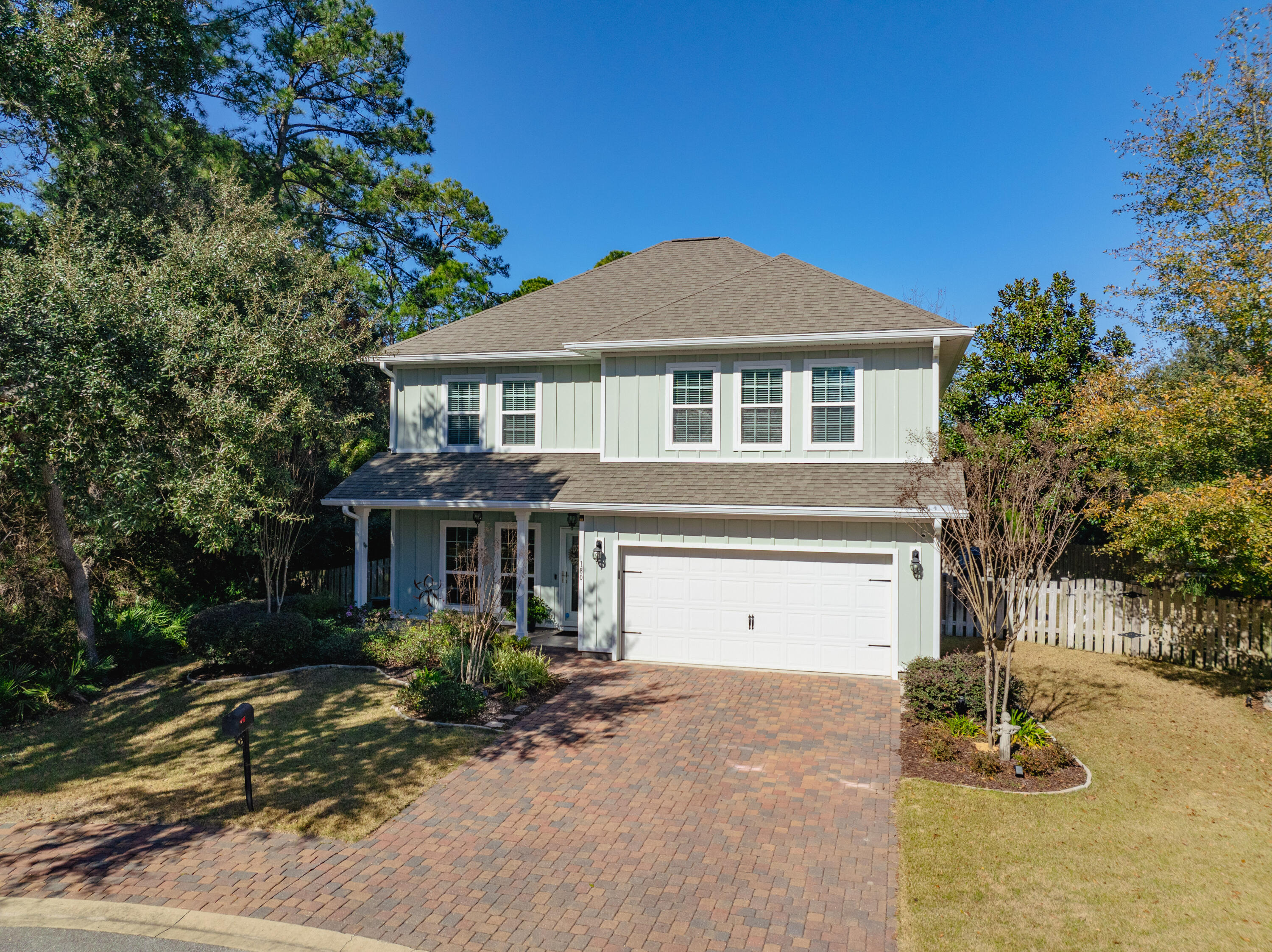 This coastal home, located on a cul-de-sac and backing into a private preserve area, offers a serene and picturesque setting. With four bedrooms and three and a half baths, the home features a spacious, open floor plan that seamlessly connects the kitchen, dining, and living areas. The two-story design includes a master suite on the first floor, providing convenient and private living. Upstairs, you'll find three additional bedrooms and a bonus room, offering ample space for various needs. Craftsman details, such as shiplap and tongue-and-groove wall and ceiling inserts, add character and charm to the home. The screened-in patio extends the living space outdoors, while the two-level backyard, complete with a retaining wall and fire pit, is perfect for entertaining or relaxing in nature. There is a two car garage. This home is being sold unfurnished. Please note that the Ring doorbell will not convey with the property. 