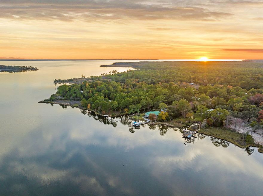 Located along Whitfield Road in Freeport, this substantial homesite offers scale, privacy, and a direct relationship to the surrounding bay system. The property fronts a wide stretch of open water, creating unobstructed views and a sense of separation that's difficult to replicate in newer developments. The landscape is quiet and expansive, with changing light and tide patterns that give the setting real dimension. The location is both strategic and restrained. Whitfield Road remains lightly traveled, preserving a residential, low-density feel, while still allowing easy access to Freeport, Hammock Bay, and the broader Emerald Coast corridor. It's an area defined more by land ownership and long-term residency than by turnover.

The parcel's size and layout provide flexibility for a properly scaled custom build; one that can take advantage of elevation, natural buffers, and long sight lines across the water. Mature vegetation offers privacy and character, with ample room for controlled clearing rather than wholesale disruption of the site. This is a setting that rewards thoughtful architecture.

Water access supports a utilitarian coastal lifestyle; kayaking, paddleboarding, and fishing in calm conditions, without the exposure of open Gulf frontage. It's functional, protected, and sustainable.

Whitfield Road represents a quieter side of waterfront ownership in Freeport; where land still carries weight, views are held rather than marketed, and the value lies in permanence rather than presentation.