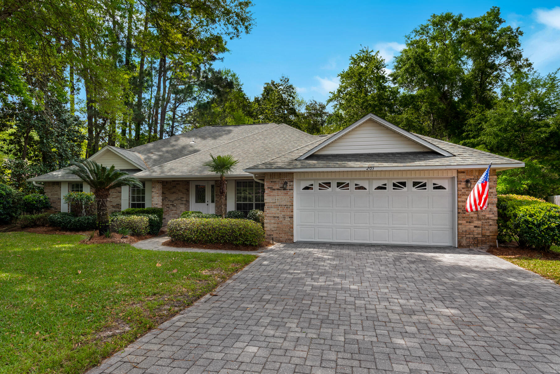 4 bedroom, 2 bathroom plus Florida room that has been lovingly maintained and updated over the years. Experience the natural beauty and tranquility of its private setting in the premier coastal gated community of Windward within Bluewater Bay. Mature landscaping and a handsome brick paver drive welcome you onto the covered patio to the front door. Inside the quality finishes and careful attention to detail are evident throughout the 2300 plus square feet of living space. The foyer greets and flows into the large den with custom travertine fireplace. The kitchen has an abundance of cabinetry, stainless steel appliances included, granite countertops, peninsula island, and a separate laundry room for extra storage. Spacious breakfast nook for casual eating and lovely separate dining room for stylish formal occasions. All bedrooms are generous in size with great closet space. The master suite has its own outdoor private patio through the slider doors overlooking the lush backyard. Master bathroom features an over sized jetted tub, separate shower with tile accents and double vanities. The exterior of this home is brick, with a lovely raised back patio with room for a fire pit and makes a perfect place to relax. Backyard is full of possibilities with plenty of room for a pool that overlooks the forest, and tropical garden. Oversized 2-car garage, pull-down attic for extra storage, recently painted epoxy floor, well sprinkler pump and beautiful paver driveway. Notable upgrades overtime include new flooring, new lights, new electrical outlets, dimmers and new HVAC in 2021. The amenities within Windward are extensive from the central brick paver gathering park; a 100ft sandy beach park with a boat dock; and zero entry to the bay for swimming just for homeowners and their guests. This home is a quick commute to Eglin Air Force Base and Destin. Buyer to verify all data and dimensions. This home is truly a MUST see for those looking for the best of the best!
