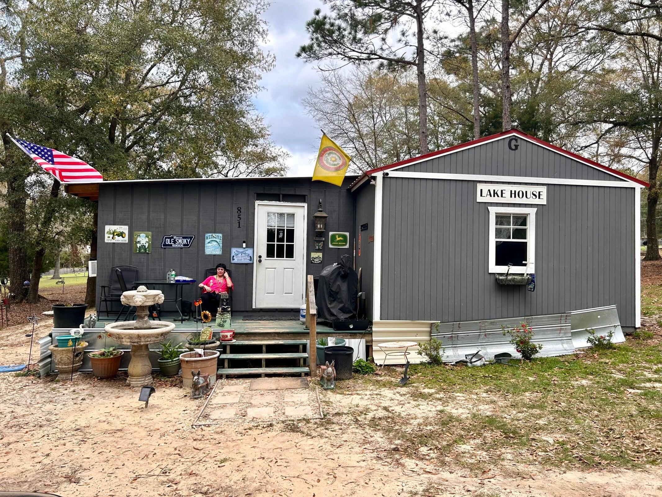 Dream come true!  Storage Building converted to a Tiny House with add on room totaling appx.  952 s.f. Now has 2 bedrooms and 1 1/2 baths.  Seller has it in ''shabby sheik and rustic interior with  a touch of  wooden pallets.   Makes a great weekender place to fish and enjoy the good life at Kings Lake, a 500+ acre fishing Lake with bream, bass, crappie and catfish.  This particular lot on the plat is Lot 1, PLUS Lot 1A....so you are getting appx.  .84 of an acre. Probably largest lot on the lake.  Yard is larger than fenced. It was not permitted at time of construction, so it is not insured.  Keep in mind the lots are valued at the sale price. The sales price is the value of the land the dwelling is a Perk!  Sale includes  RV set-up also on the property.   CASH SALES CONTRACTS ONLY.