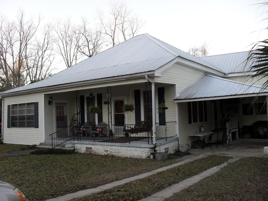Charming 1905 Traditional, that has had many updates. The floors in this home are the original hardwood flooring with intricate design around the fire place hearth. The chimney has three fireplaces. This home is built with lumber that was manufactured at the local sawmill of that era. The mantles and many of the doors are original. The Kitchen Island is made of a map chest from a ship, with extra long drawers for cookware or kitchen utensils. The kitchen cabinets or custom built with an electric cooktop and wall oven. The house is heated with space heaters and cooled with window units, however, duct work is already installed through the house and a central unit would be easily installed. There is an attic that can be accessed from the outside. The Master Bath has the original claw foot tub
