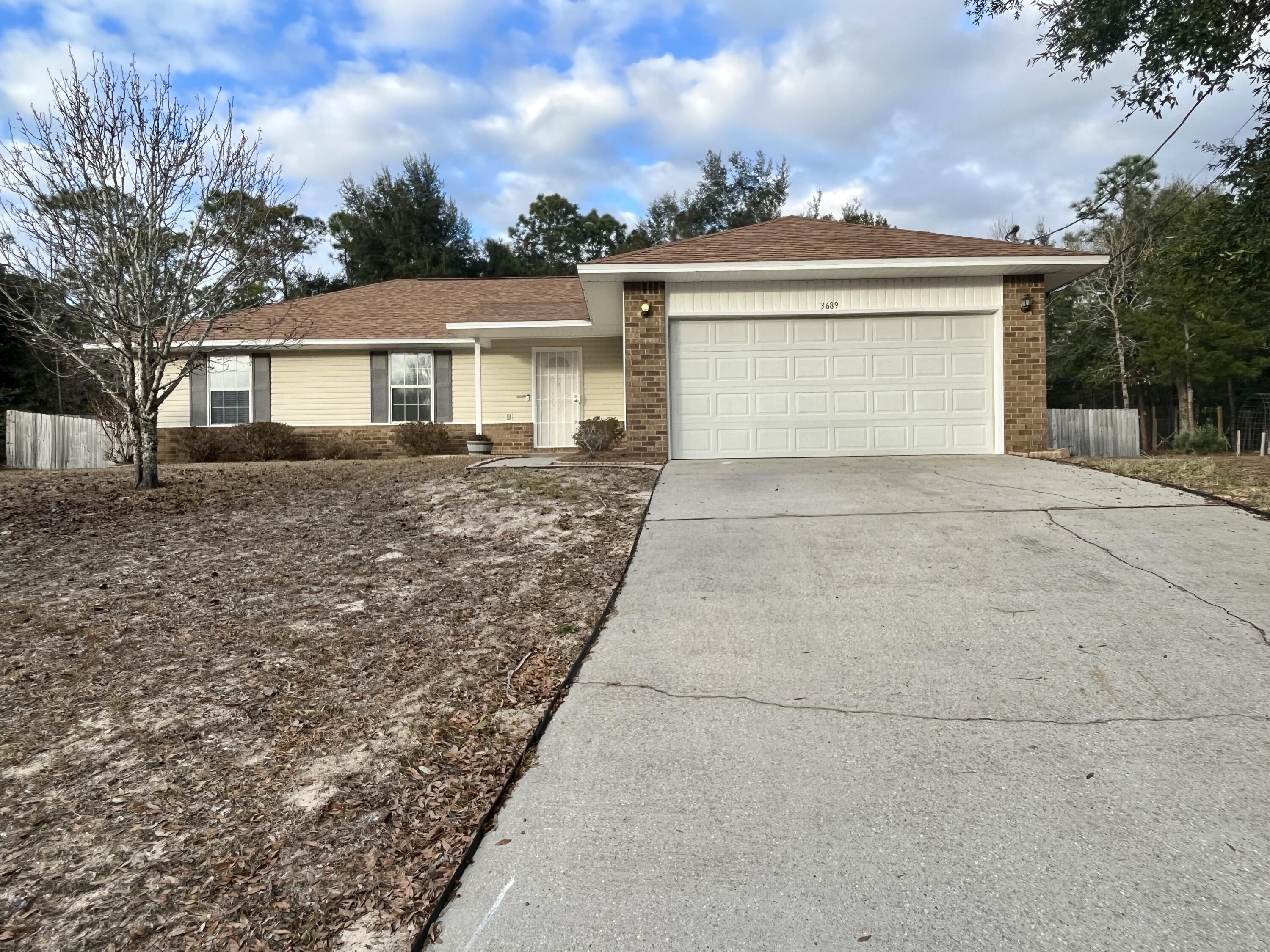 Check out this spacious 4 bedroom 2 bath home in Holley, Florida. If you are seeking a high and dry home by the beach yet still have some privacy, look no further! This home is located in a quiet cul-de-sac with 640 acres of federal land (Eglin AFB) behind you. Navarre Beach is approx. 15min away with highway 87 right there to help anybody who has longer commutes. The Split floor plan with vaulted ceilings gives a nice open feel to the home. Features include a surround sound and surveillance system wiring for easy hookup, Whole Home Air Purifier installed into the duct system for any sensitive occupants, chicken coup, storage shed, playground, fire pit, pergola  with wooden bench swing and backyard trail. Backyard is fenced with two double door gates on each side. Pets are allowed.