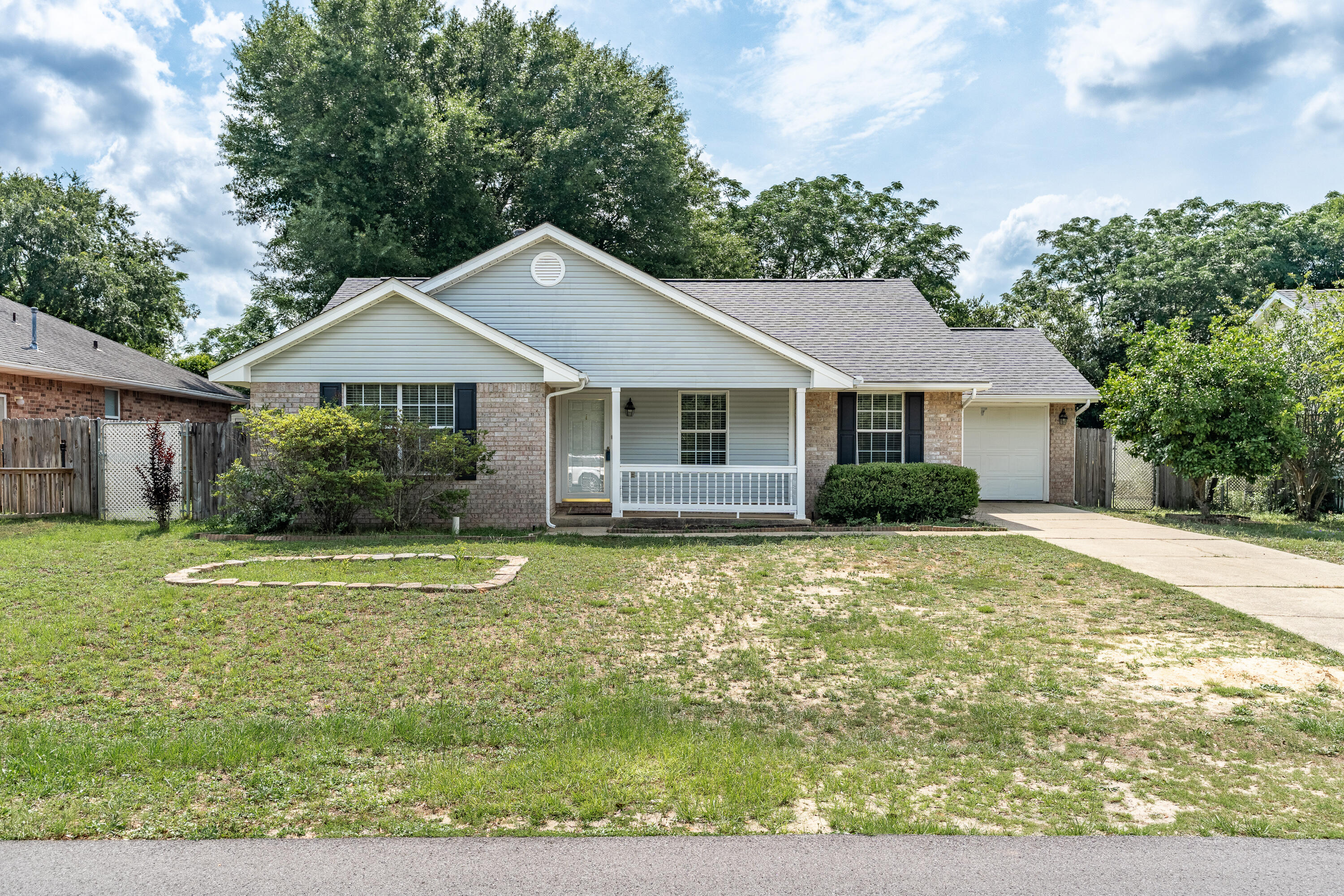 Easy Access & Modern Comforts in SE Crestview! This 3-bedroom, 2-bathroom home offers unbeatable convenience, located in Southeast Crestview with immediate access to Highway 85 and 90. The thoughtfully designed interior features durable tile flooring in the family room and kitchen, ideal for busy lifestyles. All three bedrooms provide a cozy retreat with luxury vinyl plank flooring. Prepare meals in style in the updated kitchen, complete with stunning granite countertops, a chic modern patterned backsplash, and a sophisticated suite of black and stainless steel appliances. A standout feature is the generous 300 sq ft screened porch, extending your living space and offering a versatile area for any occasion. 2020 roof. water heater 2023.