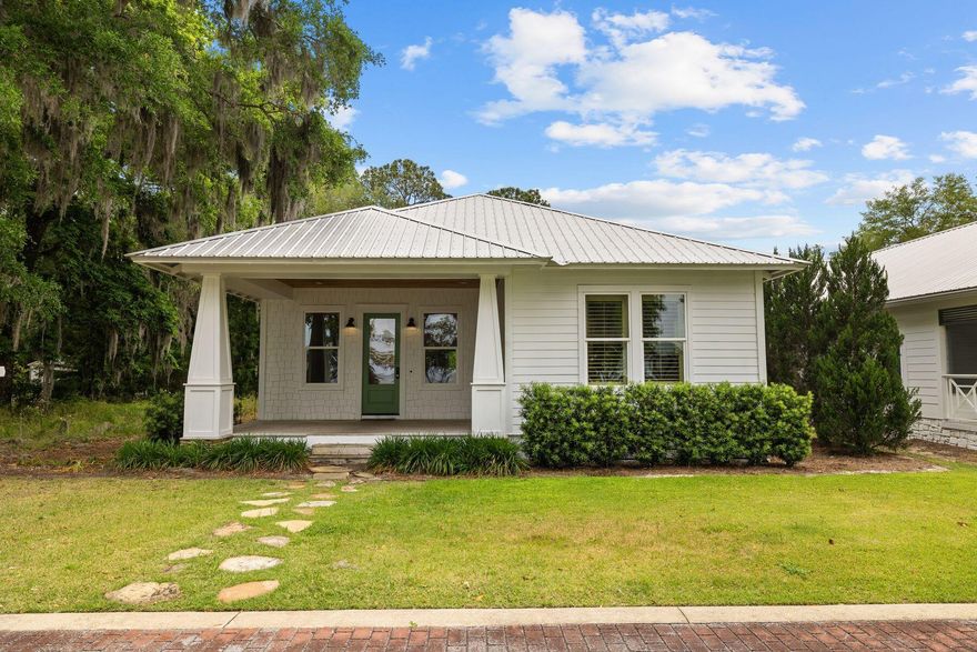 This custom Florida cottage is located in the bayfront community of Grayton Bayou on arguably one of the prettiest streets in Point Washington. Located on a peaceful cul-de-sac, it is a short distance from the public boat launch, which provides access to beautiful Choctawhatchee Bay. This spacious home has a charming front porch designed for enjoying evening breezes and blazing sunsets. It currently has open bay views as no bayfront homes have been built across from it. It will forever offer a bay view corridor due to offset lots across from it once built out. The front door opens into a huge living room with gleaming pine flooring, 10-ft. ceilings, recessed lighting and multiple windows. It provides a generous open space for living and dining. The spacious kitchen is superbly appointed with Shaker-style cabinets and underlights highlighting the tile backsplash. Granite countertops and stainless appliances provide everything you need to entertain or rustle up quick-and-easy meals served at the breakfast bar. A pantry provides additional storage and a nicely sized laundry includes a folding table, washer, and dryer. Wood flooring continues into the master suite, which has his-and-hers-closets, plantation shutters, and beautiful views of the bay and mature moss-draped oaks. The ensuite bathroom has a soaking tub, a separate shower, separate water closet and a granite-topped vanity with twin copper sinks. Two additional bedrooms and a second bathroom accommodate family and guests. Tall windows in the bonus room create a beautiful sitting room or playroom in all seasons. Head outdoors and relax beneath the pergola in the private fenced rear yard. The cobblestone patio provides a natural area for grilling and enjoying an outdoor lifestyle around the fire pit. The property includes an attached oversized garage for storing kayaks and bicycles and plenty of additional parking at the rear of the property. In addition to the nearby boat launch, there's a community pool and hot tub. Just yards away, Bayside Ranchettes Park has a dock where kayakers and paddleboarders can launch their craft. It's a great spot for fishing enthusiasts to cast a line, too.