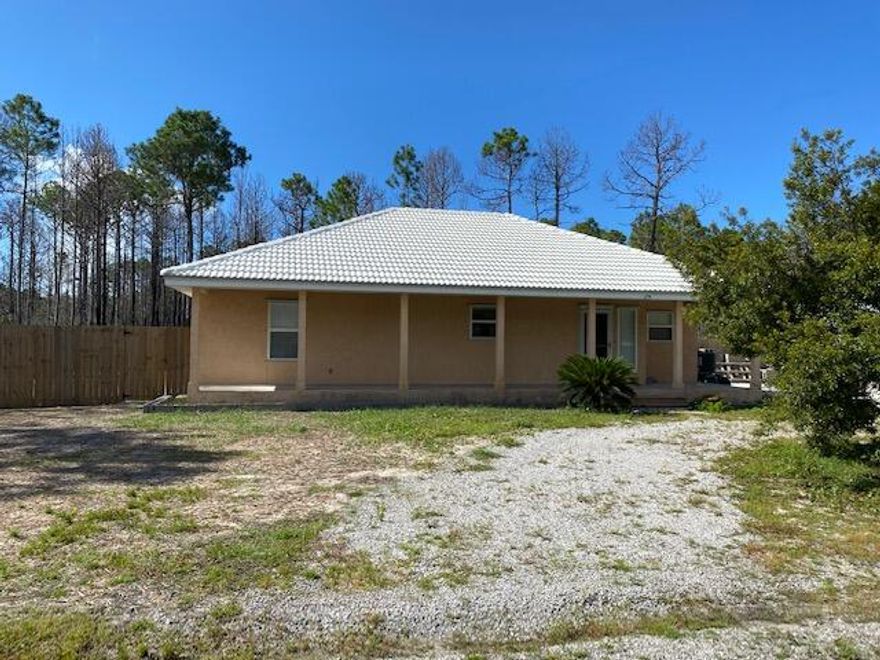 UNDER CONTRACT - Back-up Offers Accepted.  Home is being sold ''AS IS''.  Enjoy the privacy of a small neighborhood with large 1/2 acre lots on the west end of hwy 30A just a short bike ride to our beautiful white sandy beaches, restaurants, with plenty of activities festivals.  Walk into the large open floor plan to entertain and spread out.  Huge back yard fenced in for your pets and screened in back porch.  Home is very solid with concrete stucco and concrete tile roof.  Renovations made within the last 8 months include: freshly pained inside, new LVP flooring throughout the entire house, new HVAC unit and vents cleaned, new hot water heater, new gas stove, new shower enclosure and toilet,