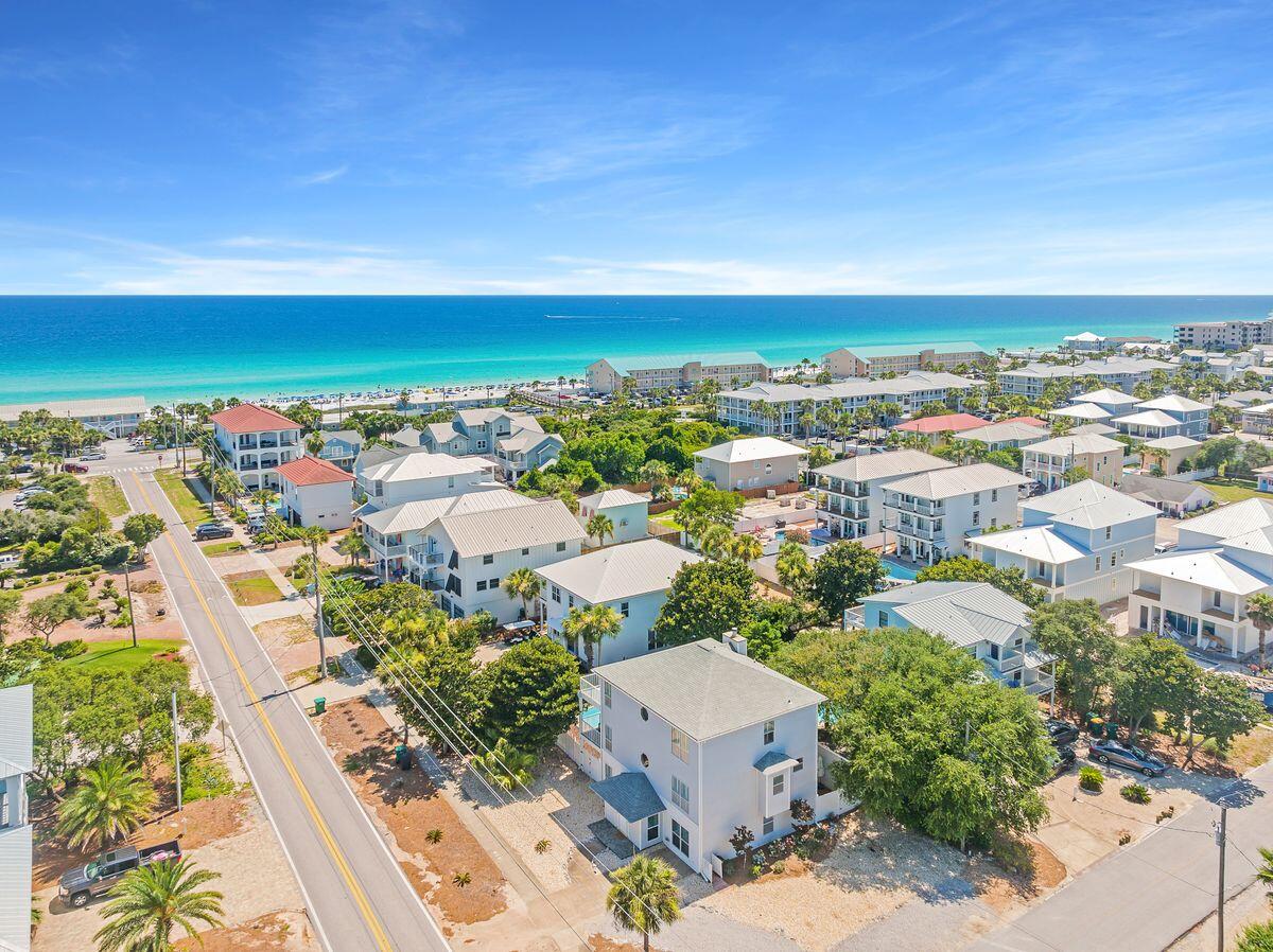 Enviably located yards from beautiful Crystal Beach, this imposing three-story beach house comes with guaranteed income and no HOA fees. Each level has a full-width balcony overlooking the (heated) pool and enclosed backyard. The covered terrace is perfect for barbecues and poolside entertaining. Stretch out on lounge chairs with a book while youngsters frolic in the water. The spacious home has easy-to-maintain wood and tile floors throughout. The foyer entrance hall leads to a large bunk room, a full laundry room and a second kitchen/utility area. There's another bedroom with full bath and a bright game room with sliding doors to the pool. Head upstairs to the main open living area. Gleaming wood flooring enhances the sitting/TV area and the adjoining dining area with fireplace feature.