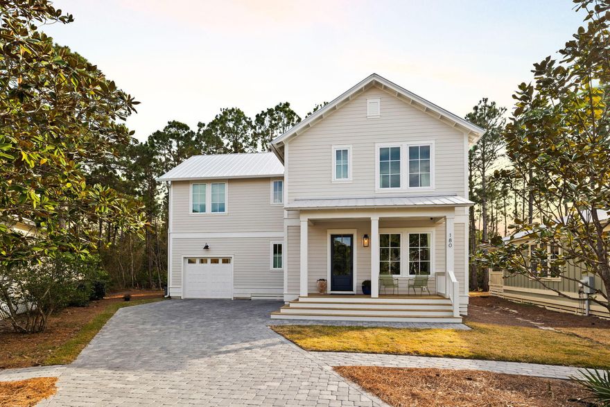 A stunning custom-built home nestled on a serene state preserve in gated Hidden Grove offers the perfect blend of luxury, privacy, and nature. This spacious four-bedroom residence is designed to maximize both comfort and the breathtaking views of the surrounding landscape. A paver driveway lined with a variety of trees and shrubs leads to a builder-owned haven designed with upgrades galore and modern living in mind. Large windows flood the home with natural light, enhancing the impeccable attention to detail and designer finishes. The gourmet kitchen boasts top-of-the-line Monogram appliances including a six burner gas range and custom hood, cabinets and tilework to the ceiling, and an adjacent butler's pantry with solid granite countertops and backsplash to provide additional storage and  prep space, ensuring seamless hosting of gatherings and dinner parties. A gas fireplace with millwork detail frames the living room for cozy evenings and entertaining. Retreat to the second level to find all four bedrooms, each providing respite and privacy. The primary bedroom suite features a natural wood vaulted ceiling, spa-like ensuite bathroom with dual vanities, and spacious walk-in closet with built-ins. Three additional bedrooms offer comfort and versatility, ideal for a growing family or accommodating guests. This home is designed with practicality and durability in mind, featuring storm-rated windows and doors providing peace of mind during inclement weather while also enhancing energy efficiency. Other eco-friendly home features include a Navien tankless water heater and smart home technology allowing you to control the comfort and security of your home while away. Entertain family and friends in the wide, grassy backyard among the breezy forest of pines and magnolias as the grapevine framing the back porch swells with extra shade and clusters of fruit. Hidden Grove is a gated community renowned for its quiet and friendly atmosphere, where residents enjoy a beautiful surrounding of mature tree-lined streets, sidewalks, a community pool, and no short-term rentals.