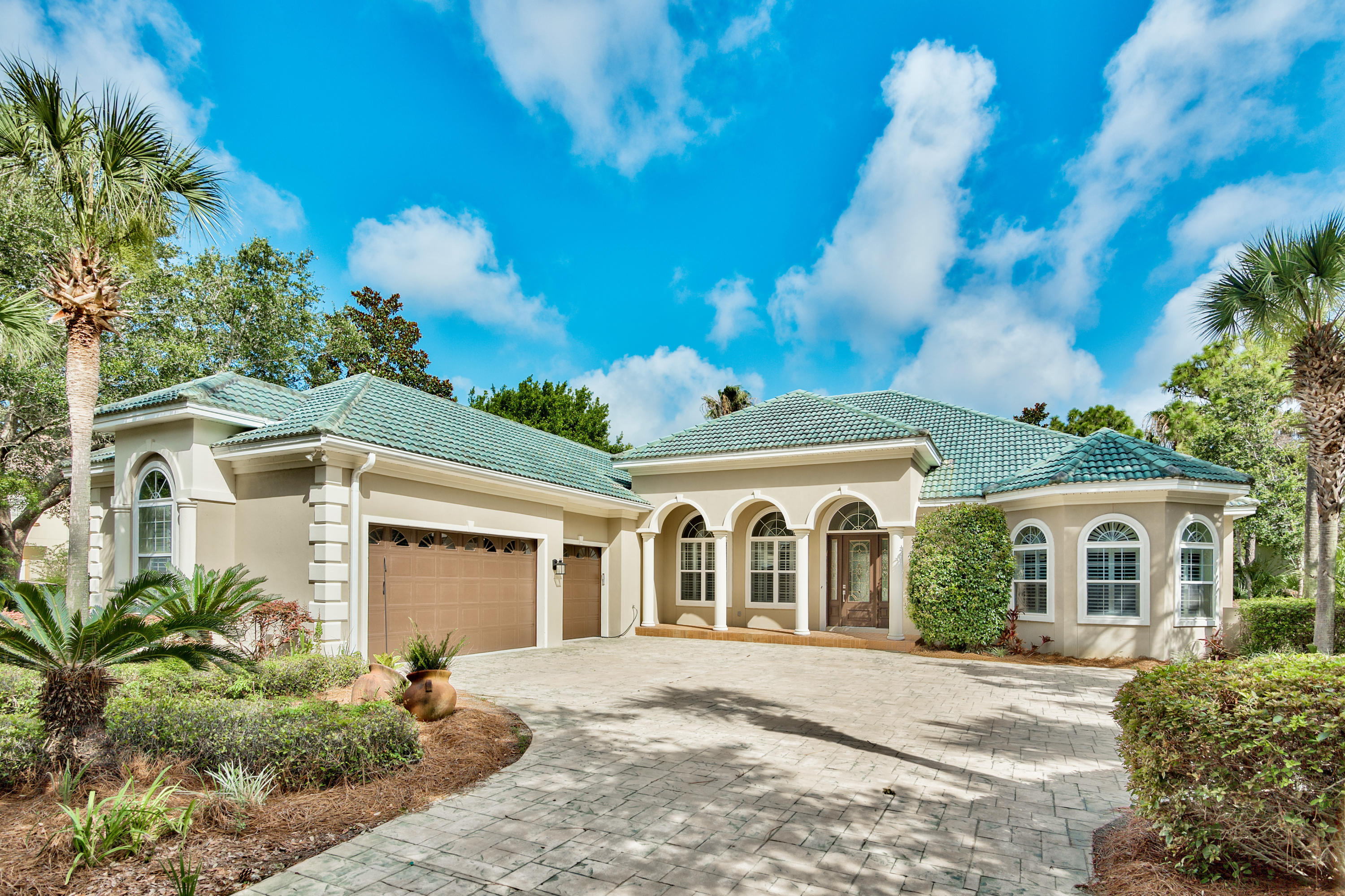 Stunning single story 3463 sq ft home on a lake with pool/spa on a large lot (.46 acres) in prestigious Regatta Bay. The home has three bedrooms all with their own baths, including a huge master suite with two walk in closets with built-ins, sitting area with fireplace, and an entrance to the outdoor living area. A nicely appointed study (which could be used as a fourth bedroom) with built-ins and closet is on the master wing of the house. The other two bedrooms are on the opposite side of the house. The outdoor living area has a large covered patio with a built-in kitchen area that opens to the deck of the pool/lanai. The open floor plan has a large family room and breakfast area off the kitchen, which has a double oven and granite countertops and a new travertine backsplash.