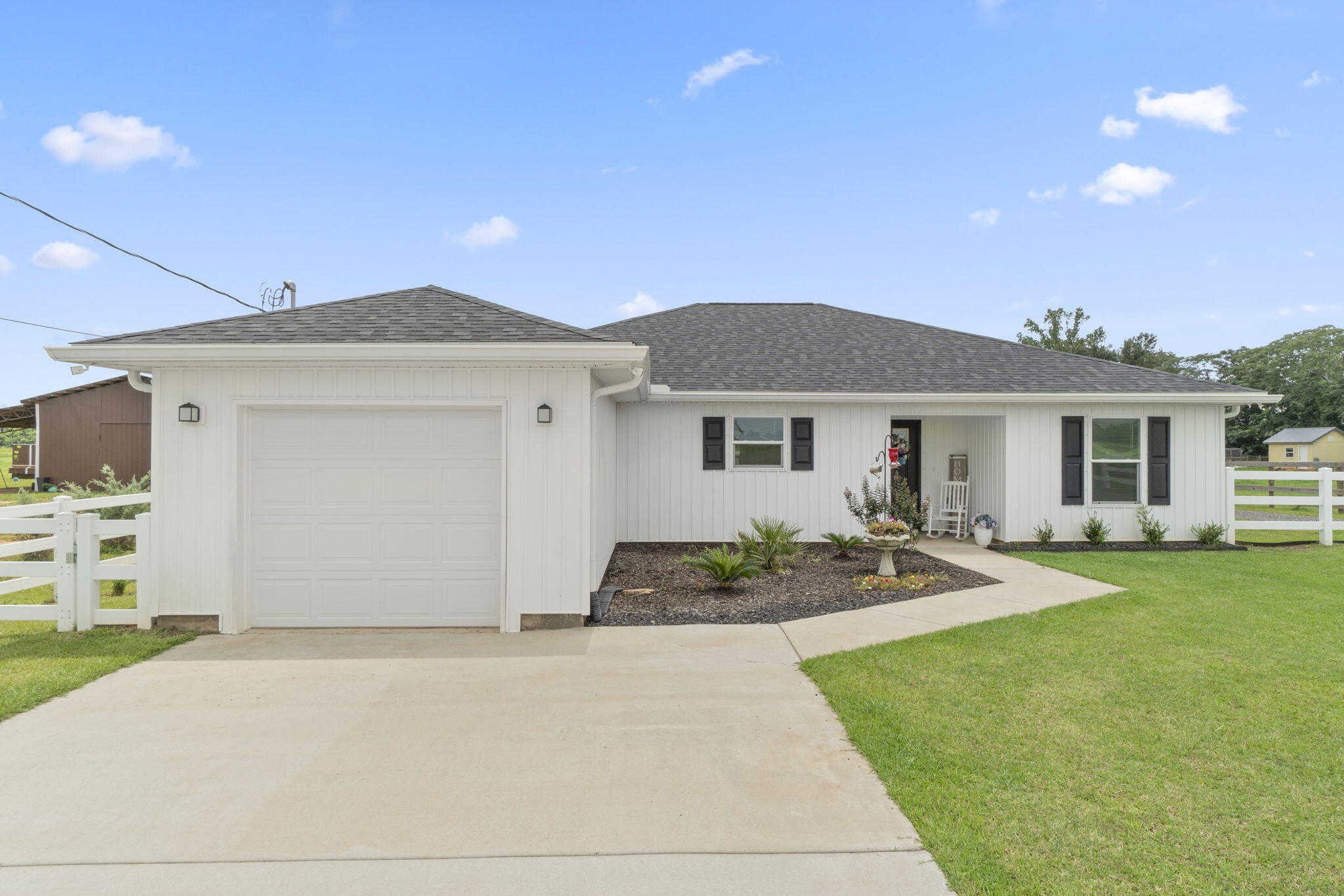 Welcome to this better than brand new 2023 build home in Jay, FL! This 3 bedroom, 2 bathroom, 1 car garage property is situated on a generous sized 1.57 acre lot - with plenty of room to spread out and enjoy the quaint, country lifestyle and beautiful natural view. Inside, you'll find luxury vinyl plank flooring throughout, and an open and split floor plan that seamlessly blends the eat-in kitchen into the living area. The kitchen boasts luxurious granite countertops, stainless steel appliances, and a wet kitchen island with 4 seater breakfast bar. The living room features a large double window with a gorgeous view of the expansive backyard, and a door leading to the covered patio. Down the hall by the kitchen is the interior door to the garage, inside laundry room, and the primary bedroom with ensuite - featuring a walk-in shower and FANTASTIC oversized closet. The 2 additional bedrooms and bathroom are on the opposite side of the home. The fully fenced in backyard has plenty of room to roam and makes the ultimate outdoor entertaining space! Featuring a newly installed shed and separate fenced in courtyard area - this could be your DREAM workshop, she-shed, man-cave, additional storage space, or whatever else your heart desires! Schedule your showing today, and make this home YOURS today!