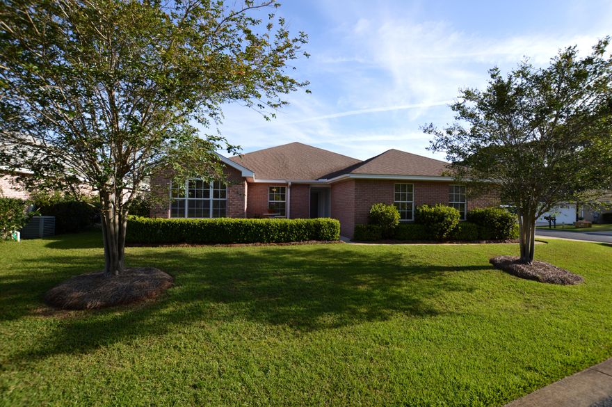 All brick well maintained home in Bayside. Corner lot and lush landscaping. Owner has taken meticulous care with home. Hardwood floors in dining and main living area and hallways, Tile in kitchen and baths. Wood look tile in laundry area. Eat in kitchen nook with kitchen island. Granite kitchen counter tops, full plantation blinds throughout home, carpet in bedrooms. Master bedroom has large walk in closet, master bath with double sinks, tub and separate shower and French doors that open up to the screen lanai. Gas fireplace, gas furnace and gas hot water heater, two car garage and immaculate. Bayside has a neighborhood pool, tennis, playground and Bayfront dock/park. Close to beaches and shopping. Owner has installed a stained glass front door and storm door.