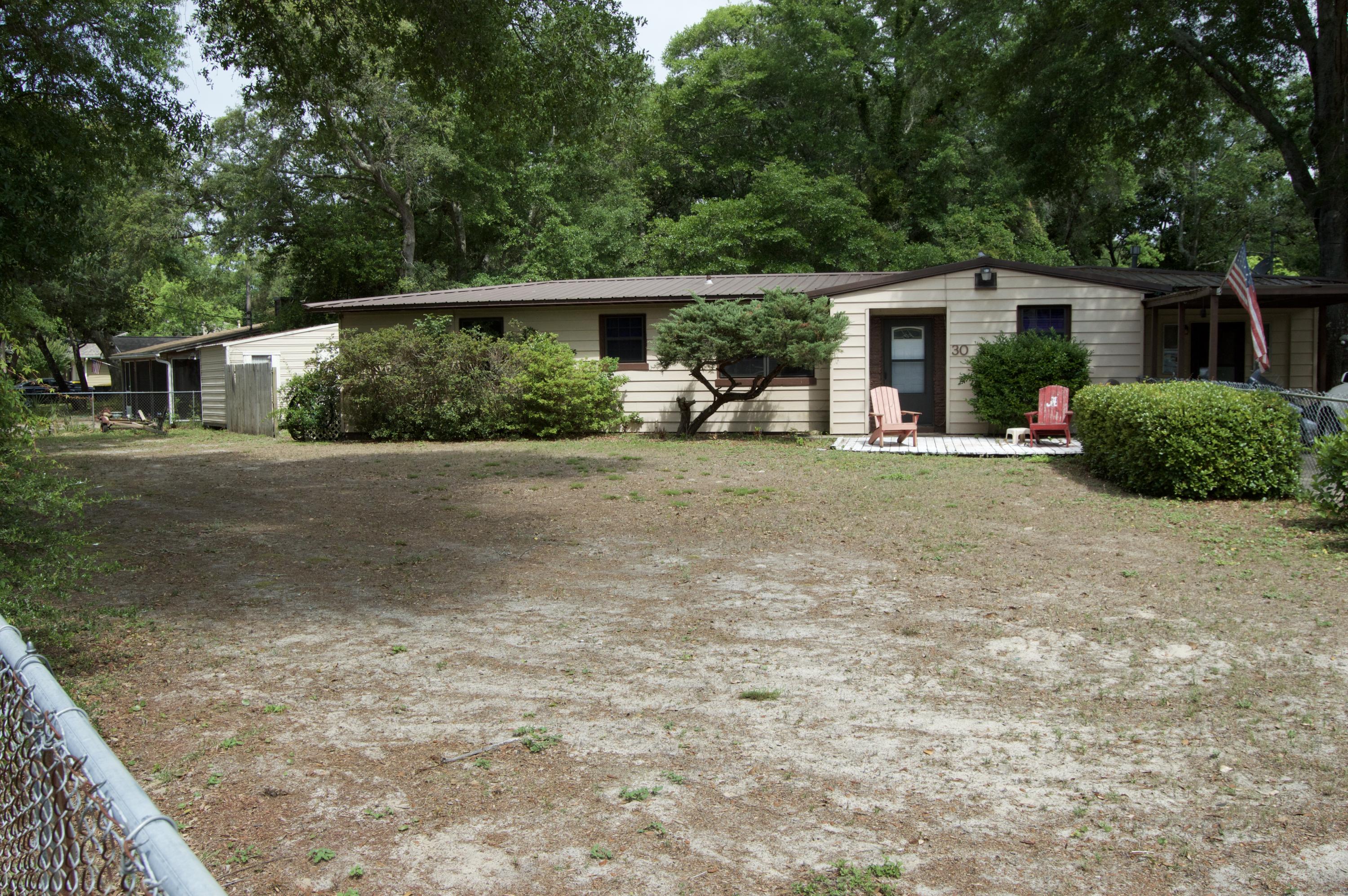 Nice home on large corner lot in sought after Elliot Point Subdivision. Great neighborhood, Close to restaurants, shopping , Beaches and Convenient to Eglin Air Force Base, Hurlburt Field. This home are in good condition. Just needs some cosmetic updating. This home offers 3 bedroom 1 full bathroom, one car carport, with an extra large two ca rparking area. Large fenced yard with 2 yard buildings for storage. Seller has done some Upgrades: New Metal roof in 2005, new a/c 2005, new windows 2005, water heater 2000, all electrical and plumbing has been updated. Updated cabinets in kitchen & appliances. utility room off kitchen with washer and dryer hookups. The back room has been opened up for more living area.