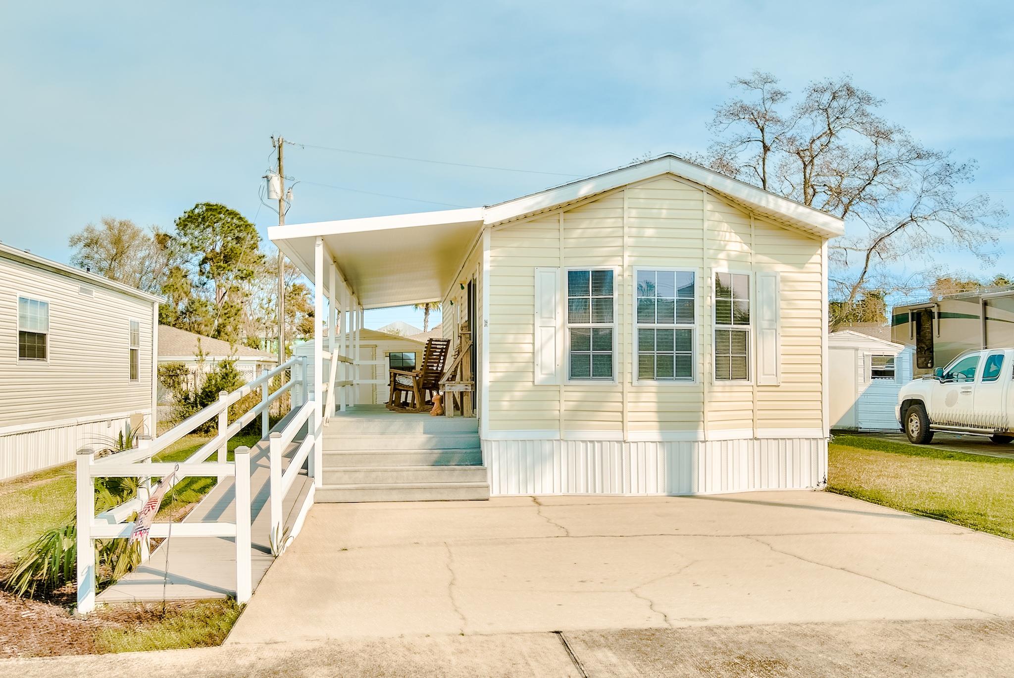 Awesome location... only 2 blocks from the beach! This home is located in the gated community of Fox Run. Nice open floor plan, with large living room, abundant cabinetry, and endless counter space. After a day at the beach, relax and take in the sunset on the covered patio. The home is one of the few that is handicap accessible with a wheelchair ramp. Indoor laundry and outdoor utility building complete the lifestyle of living at the beach. The seller has also just put on a new roof (April 2021) and is now perfect for primary living, investment property, or second home. (Buyer to verify square footage)