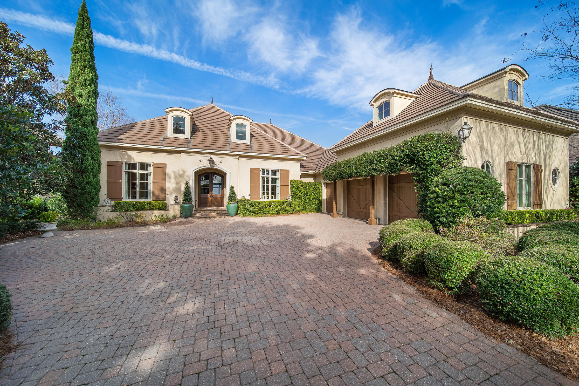 French Riviera on the Choctawhatchee Bay-A cherished home offers gracious living in a French country design. This one of a kind home is perfectly situated in the upscale neighborhood of Regatta Bay Golf & Yacht Club, offering amenities expected of an extraordinary lifestyle. Four bedrooms, plus a generous size study await a new family!The foyer announces elongated views to the amazing Bay. A spacious gathering vestibule flows to living and dining rooms where large crowds can easily gather. Fireplace and surround in living room is artistically designed with antique and glazed-aged painting techniques. The living room opens to an extensive lanai, which showcases a Mediterranean style pool and spa. The veranda offers a gas fireplace, summer kitchen with upscale appliances, a pool bath and breathtaking views of the bay. Impressive 19 ft. soaring ceilings in the kitchen-family room are finished with reclaimed cedar along with rough hewn solid cedar beams. Viking kitchen appliances include refrigerator, gas oven, electric self-cleaning oven and warming drawer. Beautiful warm granite counters compliment both the kitchen and bar areas. Off kitchen hallway, is a charming guest powder room.
Main living area floors are graced with French-design pattern of Noce travertine tumbled-edged stone imported from Turkey. Four over-sized sliding doors disappear into the walls to let the outdoors in from living, family room, master bedroom and study.
Custom designed fireplace and mantle in the family room are enhanced with built-in bookshelves and highlighted with subtle glazing. Huge bank of windows showcase live oaks, night landscape lighting, azaleas, hydrangeas and stone path to the bay - all provide an enchanted garden-setting on the water.
The study is large enough for a sofa-sleeper for that over-flow of guests. Currently serving as a home office, the study has a custom-built his and hers desk, hand scraped wood flooring, full view slider doors accented with an arbor, patio and bay views.
Architectural details are numerous throughout the home with arched entryways, ceiling heights vary up to 19 ft., engaged columns add distinction to the main living areas. The master suite enjoys pool, garden and bay views. The master bath is entered through double doors that introduce his and her closets, a soaking tub, remote-controlled window treatment, and double vanities. Two guest bedrooms downstairs, ensuite, are nicely appointed, and carpeted for comfort. One story living with a large bedroom/game room full bath and hospitality closet located upstairs as a private guest retreat. An unfinished attic area presents possible expansion.
The 70 ft. trek-floored dock to the bay is the perfect oasis to enjoy cocktails and gorgeous sunsets. Regatta Bay, bay front living is truly unique.
Regatta Bay residents and their guests enjoy walking trails, stocked lakes, 2 rubico lighted tennis courts, pickle ball courts, Olympic size pool, kiddie pool and playground. Regatta Bay Golf and Yacht Club is top-rated in the state of FL. This exclusive, gated neighborhood, is located adjacent to Destin Commons Mall, Whole Foods, Lulu's Grill and Legendary Marina. The Gulf of Mexico and its white sandy beaches are just a few blocks south! Buyer is to verify all important data.