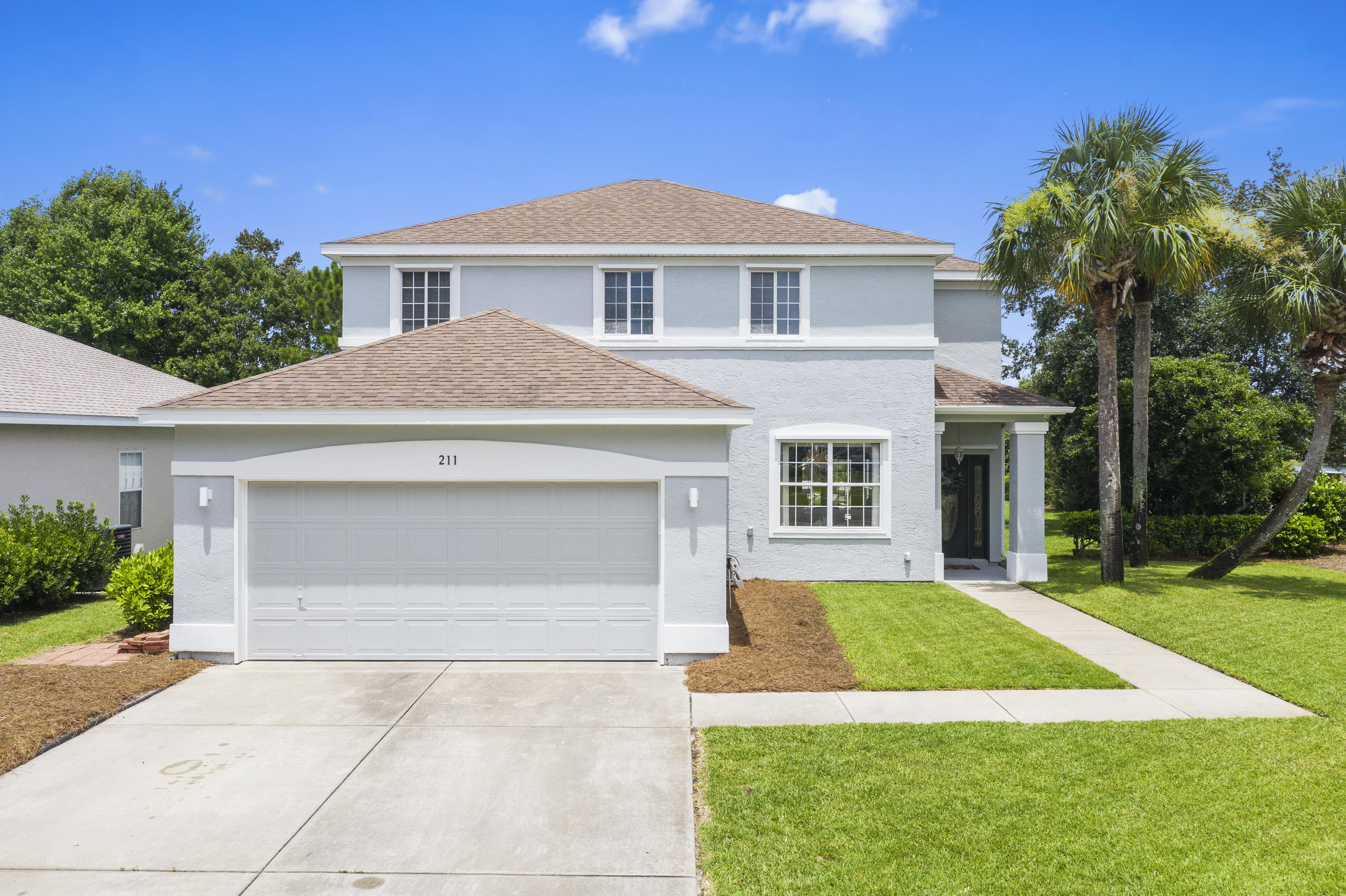 This spacious, two story Palmetto Trace home will provide plenty of living space for your family. The newly painted exterior and well manicured yard invite you into this impressive three bedroom, three full bath home. As you enter the front door you are welcomed into the living room and sitting area overlooking the front yard. The kitchen provides plenty of room for family gatherings with granite countertops, stainless steel appliances and a gas stove with convection oven. Just off the kitchen are two pantries with a laundry room. French doors off the living room and the dining area, provide easy access to the covered lanai and saltwater pool. Continuing on the first floor is a full bathroom and office which could easily be converted into a bunk room.