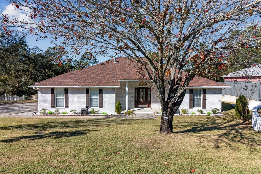 Well-maintained, all-brick 4-bedroom, 2-bath home located in the heart of Rocky Bayou Country Club. This open-concept home offers a bright, light, and airy feel throughout and backs up to a serene nature preserve, providing privacy and peaceful views. The kitchen features quartz countertops, stainless steel appliances, and a gas stove, flowing effortlessly into the main living areas ideal for everyday living and entertaining. A cozy fireplace adds warmth and charm to the interior. Enjoy relaxing evenings or your morning coffee in the screened-in Florida room overlooking the large, fully fenced backyard. The home offers low-maintenance neutral flooring, new wood flooring installed in 2023, and new carpet in 2024, with tile throughout additional areas of the home. Equipped with an irrigation system, this spacious yard is perfect for families, outdoor projects, or gatherings. Major updates include a roof replaced in 2020 and HVAC updated in 2023. Conveniently located close to highly rated schools, shopping, and an exclusive golf course, this home blends comfort, style, and an exceptional location.