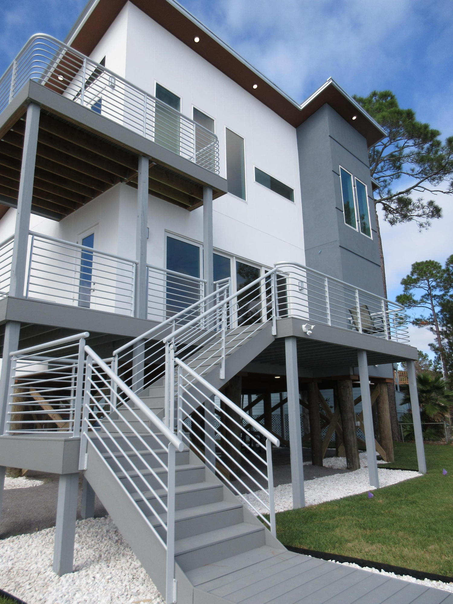 Available 12/10/18. Waterfront in Niceville - New Construction Contemporary, 3 bedroom / 2 Bath home. Owner's transfer is your Win!. Amazing attention to detail in this low maintenance custom home. Wood look tile floors are perfect for homes on the water. All NEW kitchen appliances, tankless water heater, sprinkler system, low maintenance yard, and built in closet systems to help reduce furniture needs. Then the bathrooms - WOW. Vessel sinks, stone shower floors, gorgeous tile shower surrounds with large glassed openings, Custom shower and spray heads with ambient lighting for shower and mirrors, in-shower towels bars - you name it - this home has it. Master bath also includes soaker tub, large walk around shower and separate water closet add to the list. CLICK MORE for additional info