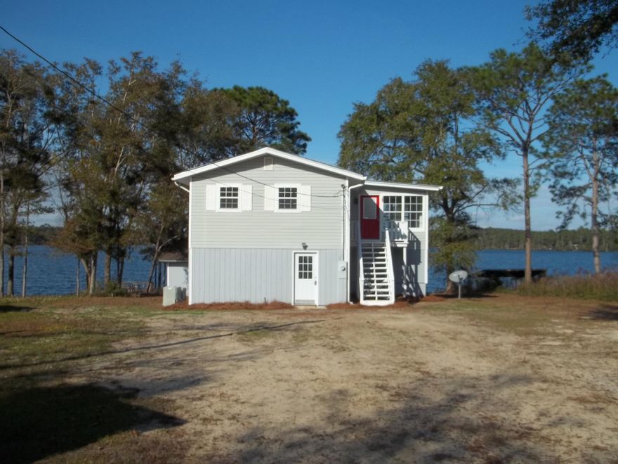 Breath taking views from this nice unique home or from your very own dock on Lake Juniper.  2 bedrooms & 1 bath upstairs and 2 bedrooms & 1 bath downstairs. Home has new flooring, ceiling fans, appliances including a washer and dryer.  County site sates its 1508 sq ft. but with measuring the home it is about 2000 sq ft. Home is on public water but does have a private well (seller not sure of working condition).All matters of importance should be verified by buyer.