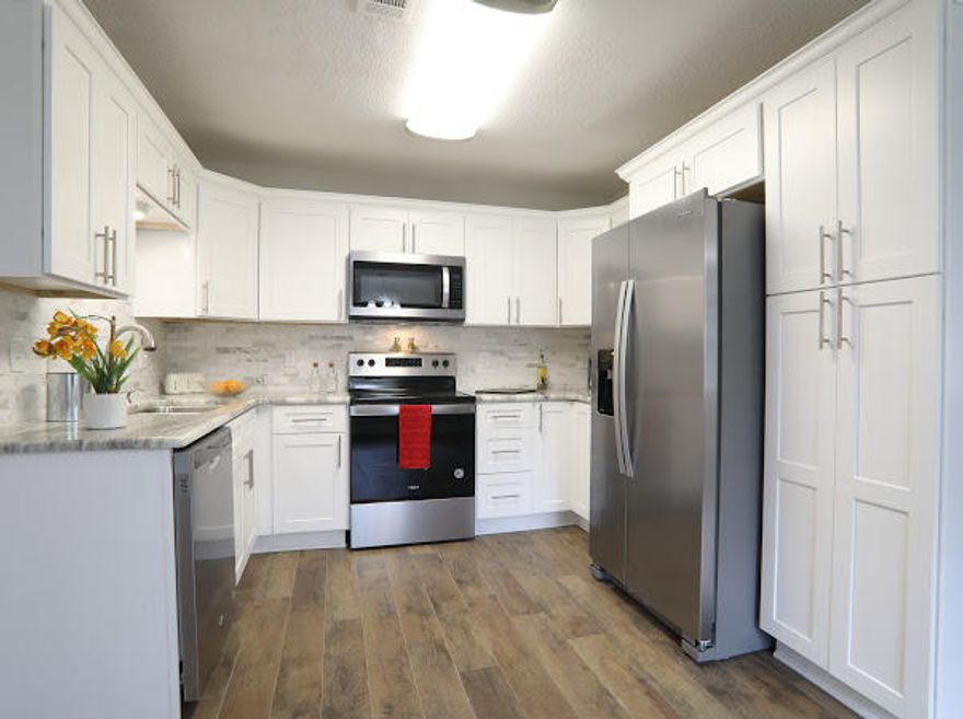 New Roof, Custom Kitchen with granite, stainless steel appliances.. Custom bathrooms, new doors, new fans and lights, ac 4 years old, please verify, new hot water heater, new laminate flooring and carpets in bedrooms. New paint in and out.. To many details to list.