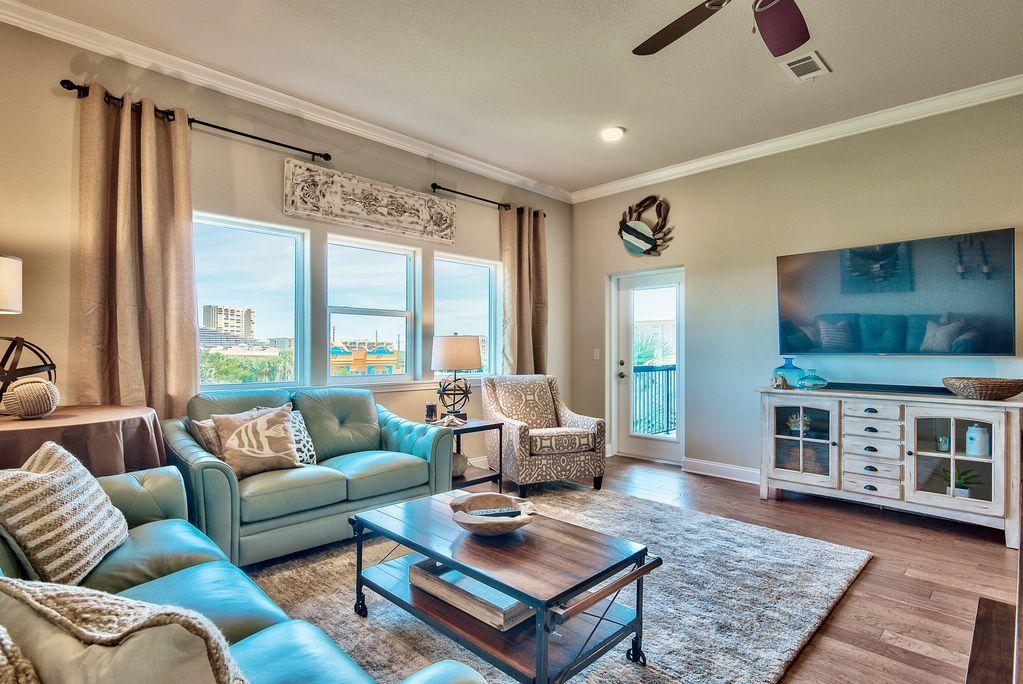 ONLY 100 STEPS TO THE BEACH! Must see unit with view of the Gulf from the balcony. This 3 bedroom 2 bath condo is a great primary, secondary or investment home. One bedroom has custom built-in bunk beds and sleeps 5 people with the total sleeping capacity being 9. Each room offers well appointed furnishings & large TV's. Hall bath features granite & nice soaking tube/shower combination. Hardwood flooring throughout the home except the nice bathrooms. The gorgeous kitchen is a chef's dream that opens into the spacious family room. Large island that seats 5 people and a farmers table so ample seating for all guests. The large family room offers comfort for after a long day at the beach. Master Suite offers large shower & separate soaker tub. This is a must see!!!!!