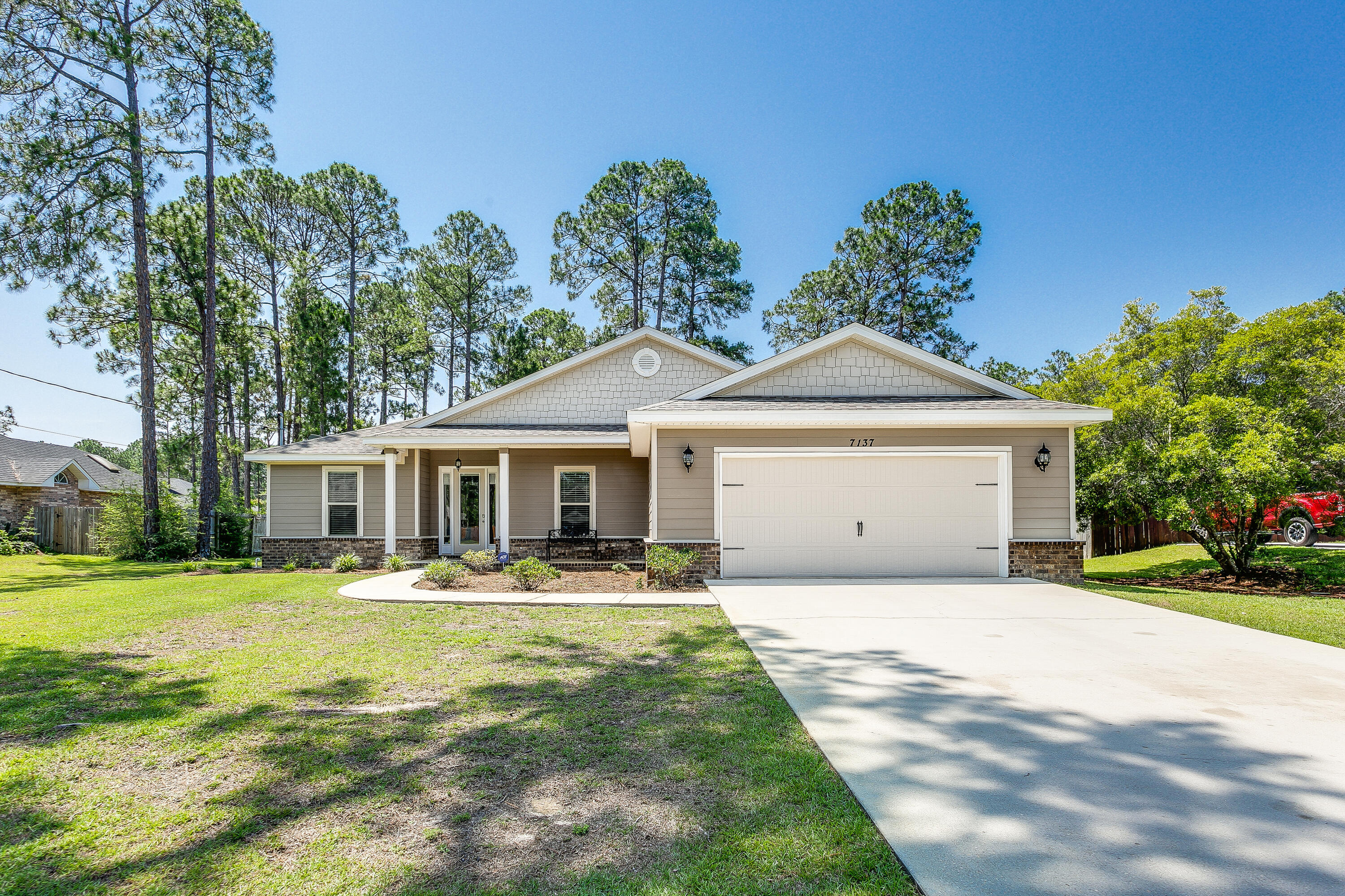Stunning home in Holley By The Sea! 4 bed, 2 bath home is move in ready, wood laminate flooring in the open concept living room with high ceilings. The kitchen has many upgrades; granite counters, soft close cabinets, touch faucet, under cabinet lights and stainless steel appliances with a breakfast bar and dining area. The bonus sunroom has plenty of space and natural lighting and is heated/cooled allowing for many uses. The main suite is spacious with high ceilings, main bathroom has a soaker tub, dual vanities and updated tile shower that will have a glass door installed before closing. The backyard is huge with a shed that conveys as is. Home is wired for ADT security system. Custom blinds convey.