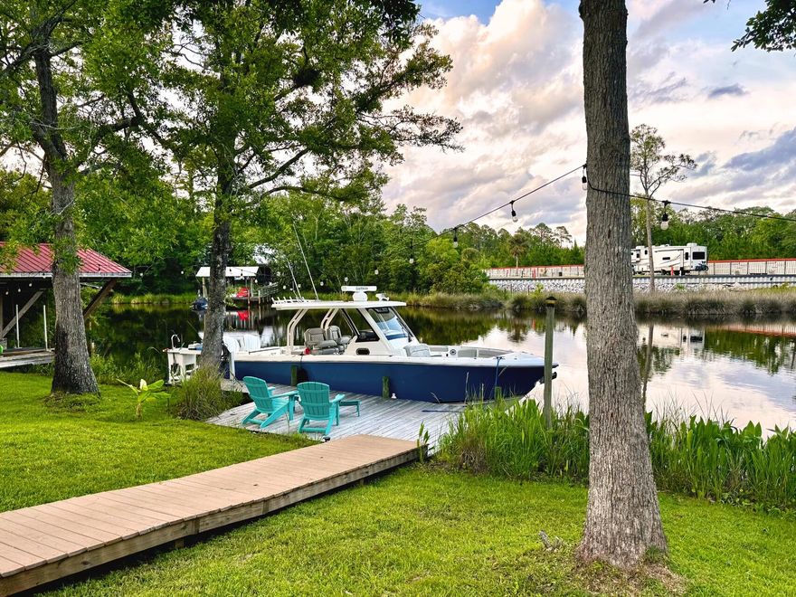 Beautifully renovated, immaculate waterfront retreat and boater's paradise with Bay and Gulf access, and no HOA! Enjoy 130' of waterfrontage on a premium lot, a private dock, boat lift, fish cleaning station, and plenty of boat, trailer, and RV parking. Set on a spacious .72-acres, perfect for a pool and garden. Ideal for boating, fishing, paddleboarding, or relaxing in the gorgeous family room with 180 degree water views. Your guests wil love the covered waterfront patio complete with a bar. Inside the home, a light-filled flex room/formal dining area welcomes you. The kitchen and bathrooms feature granite countertops. Stainless Steel Appliances anchor the airy kitchen. Rainbird irrigation and a generator hookup add convenience and peace of mind. Super fast Fiber Optic internet is available. Enjoy abundant storage with an attached garage and expansive walk-in pantry. The property was professionally appraised and valued at $884,900 - offered to you now below market value for instant equity and wealth building. Situated just moments from multiple boat ramps and marinas, and a wonderfully short drive to the renowned beaches of 30A with their powdery white sand and sparkling turquoise waters. This Freeport residence offers tranquil waterfront living with convenient access to Santa Rosa Beach and Destin. Invest wisely - invest in waterfront property, a limited resource. Would you like to live where others vacation? Schedule your private tour today. 