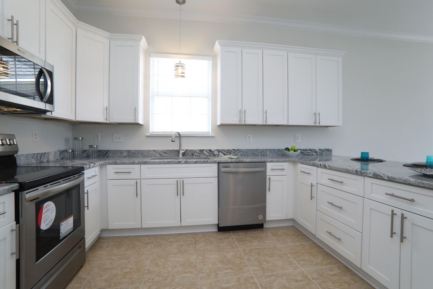 WOW.  LOCATION, LOCATION, LOCATION.  Looking for a home within minutes to shopping, schools and work then this is your home. This beautiful home features new interior paint, lighting, blinds, all new kitchen (cabinets included), Stainless Steel Appliances, Granite Counter Tops, lighting and new baths to include new tiles showers, tub, granite counter tops, mirrors, lighting .  Home has two living areas, large kitchen, fireplace, split bedroom design,  4 bedrooms 2 baths with 2 car garage.  10 foot ceilings, crown molding, split bedroom desig