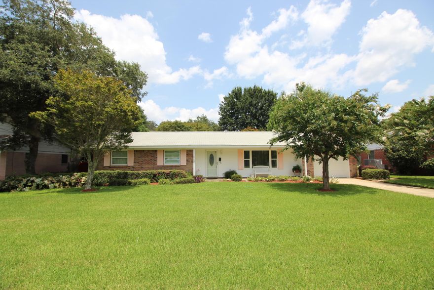 PRIDE OF OWNERSHIP SHOWS THROUGHOUT THIS BEAUTIFUL HOME! Enter through the new leaded glass front door into the foyer. Spacious living area with a large picture window. Dining area opens into the living area perfect for dinner parties. Family room has sliding glass doors that lead out to a large covered patio and fantastic views of the park-like backyard. Light and bright kitchen with granite counter tops, new cabinets, smoothtop stove. Enjoy the backyard views from the window over the sink in the kitchen. Master bedroom has its own private bath. Two additional bedrooms and a full bath complete this perfect package. Garage has a workshop area. Lush, fully landscaped backyard looks like a botanical garden. Seller has installed new high impact windows, hurricane shutters