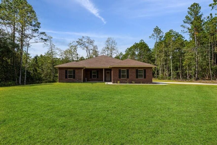 Exquisite Custom built all brick home with ACREAGE. This 4-bedroom 2-bathroom home is in one of the most peaceful locations with a lot of privacy and greenery. The home sits on a fully sodded 2.38-acre lot and has a pond in the backyard. The  driveway is gravel and oyster shells and is exceptionally long. There is plenty of space to add pool barns, workshop, and even a pool. Buyers will have space for RV, Trucks, boats, tractor or any other large equipment and vehicles. There is barley no through traffic on Four Flag Rd. The home has custom features and stunning finishes inside. The kitchen features a large pantry and a larger surface top kitchen island/breakfast bar with plenty of cabinet space. All counter tops in this home are granite in kitchen and in bathroom. The owner bathroom has a