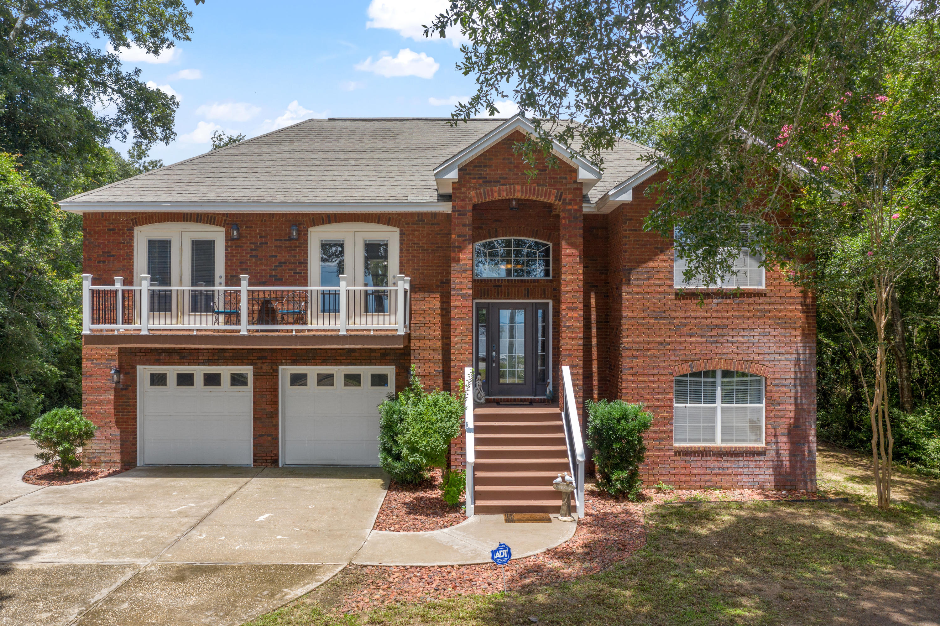 Spectacular view of Choctawhatchee Bay on nearly three quarters of an acre. Beautiful two story family estate, 3 bedroom, 3 bath with large bonus room, brick home with 75 feet of Bay frontage. Dolphin watching or relaxing while enjoying our wonderful Florida sunsets. This double lot extends from Hwy 20 to Live Oak Rd. Plenty of room for a pool and the additional lot behind to build a spec home or income producing rental home. Split bedrooms upstairs with a full sized recreation room and full bath downstairs. Master bedroom and dining room have private balconies overlooking the bay. Wood-burning fireplace in the living room. Back elevation has elevated deck on second level. RV hook-up.