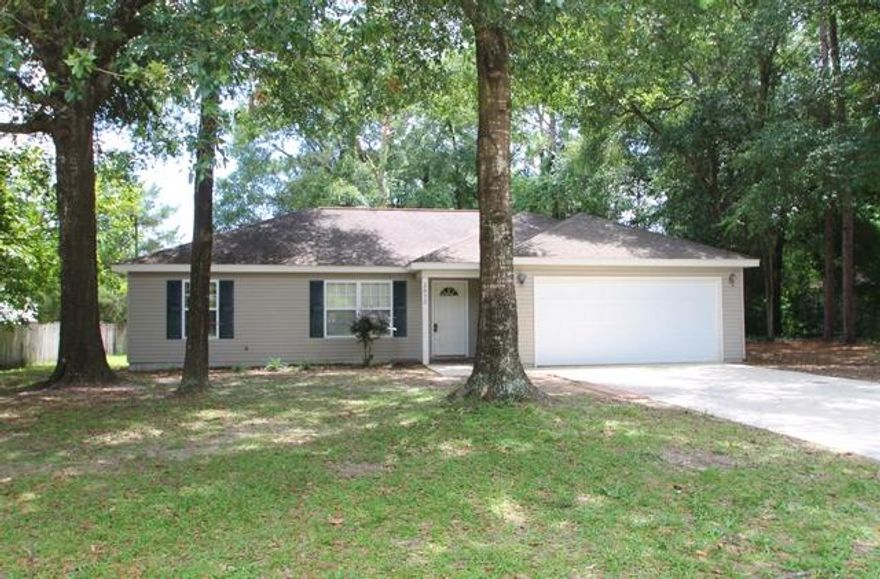 Beautiful home close to town and schools. This house features a spacious open design. Popular split bedroom floorplan.  Large great room with vaulted ceiling leads into nice sized dining area.  Kitchen is a galley style and has all appliances.  There is a new microwave range hood on order. The master bedroom has a very large walk in closet.  Roomy inside laundry room is a big plus! The two car garage features extra space for vehicles and storage. This home is situated on the large lot in a way that leaves plenty of room in the front and back to enjoy the outdoors in your yard. The property  features gorgeous mature oak trees and is nice and shady.