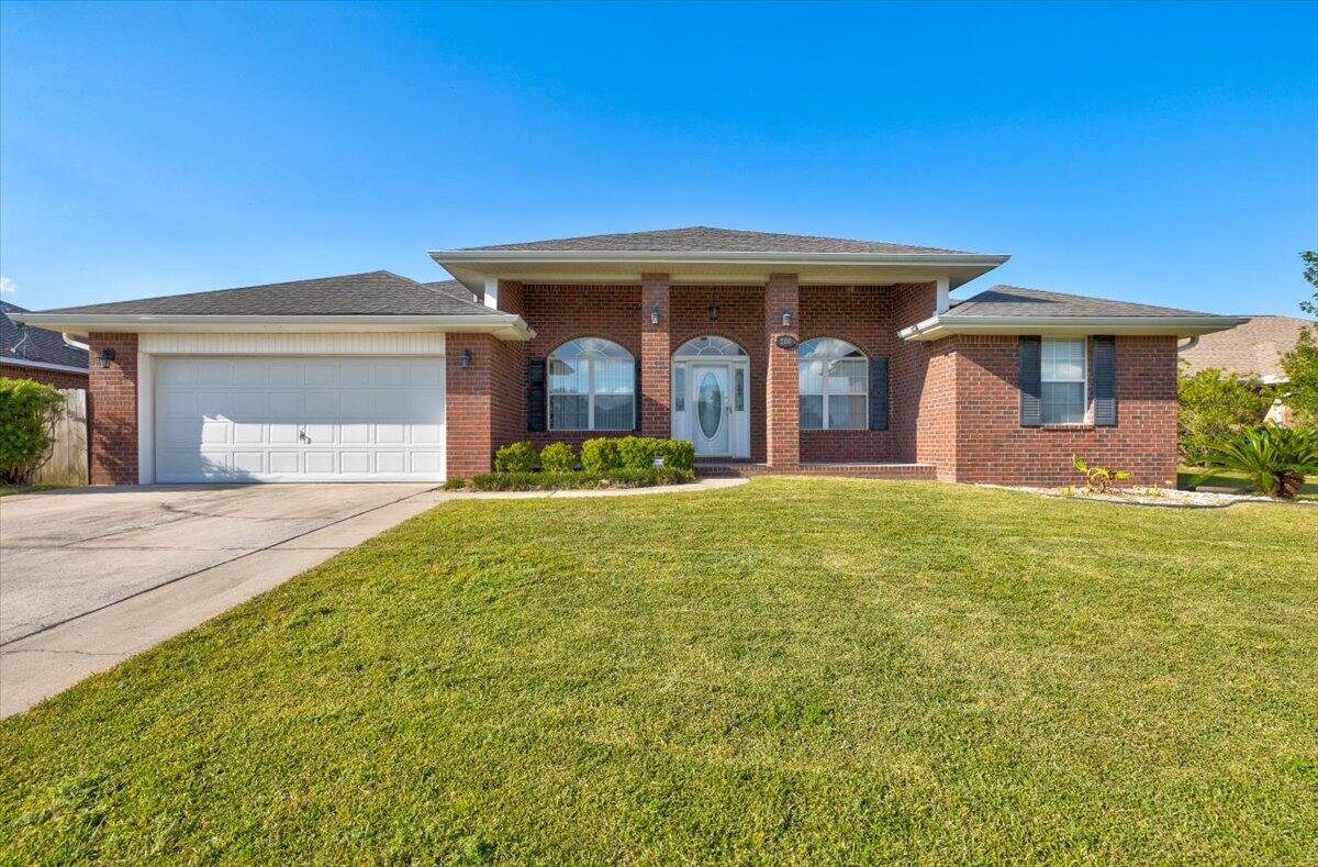 Stately all brick 4 bed / 2 bath Crestview home with new wall to wall carpet, new paint, and new quartz counter tops. Stately columns and sconces greet you as you approach your new home's oversized driveway.  Stepping inside, note the abundant light from the triple bank of elliptical windows.  To the left is a dining room with kitchen access, to the right is the front sitting room--a perfect place to greet guests--or, it could function as an office or playroom.  Continuing through the spacious foyer, the living room opens to cathedral ceilings with a wood burning fireplace and open floor plan between the breakfast nook and kitchen, and access to the back patio and large fenced-in backyard.